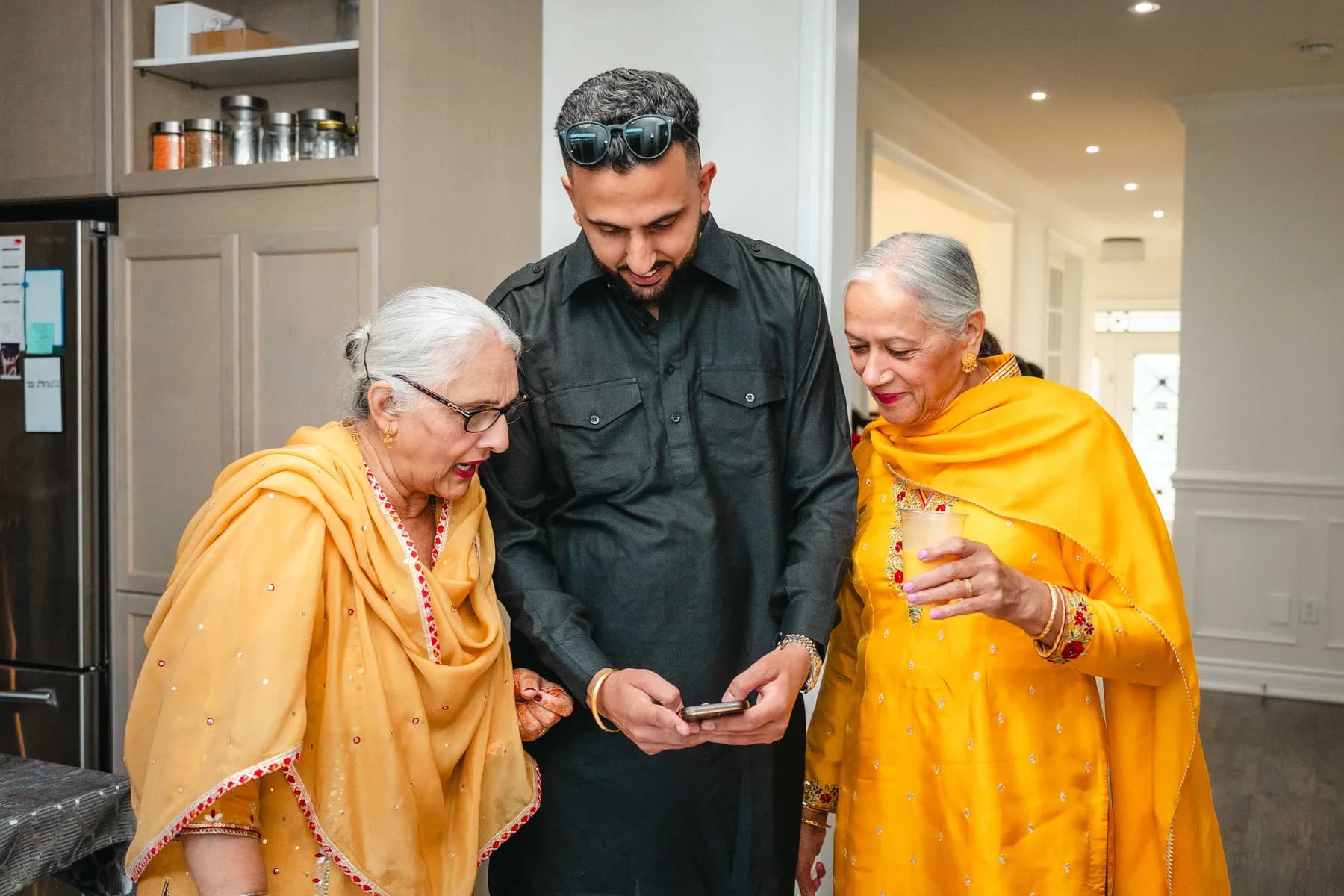 Guests talking and posing together at Aaron’s Haldi celebration.