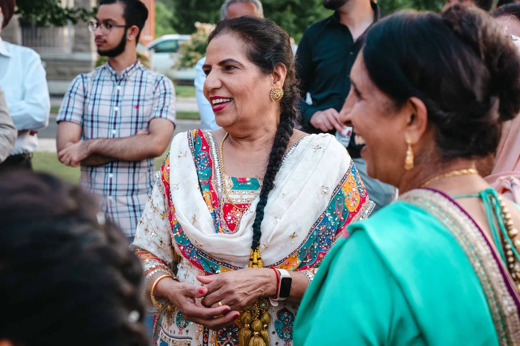 Guests greeting each other outdoors at Aaron’s Haldi celebration.