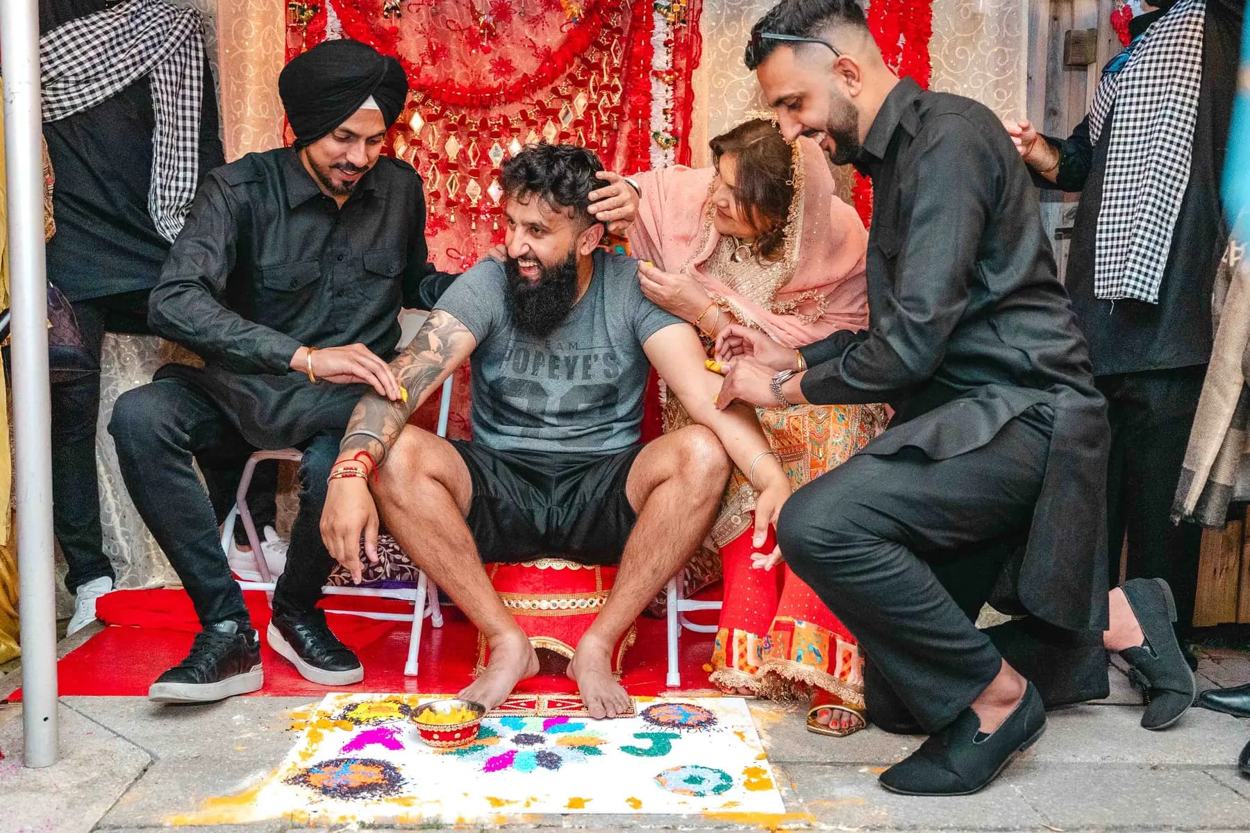 Guests applying colour during the Haldi ceremony at Aaron’s Haldi celebration.