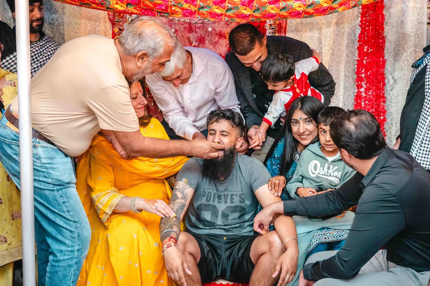 Guests applying colour during the Haldi ceremony at Aaron’s Haldi celebration.