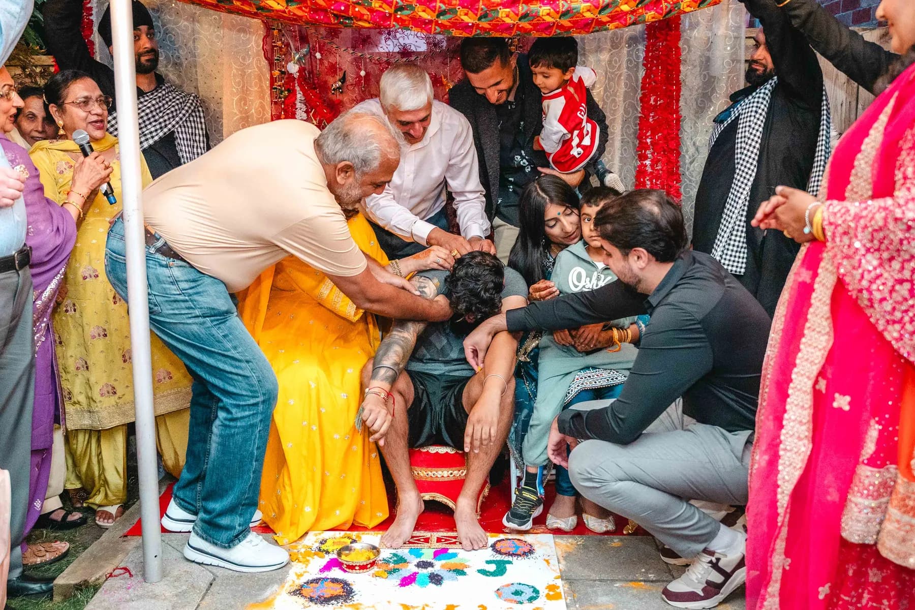 Guests applying colour during the Haldi ceremony at Aaron’s Haldi celebration.