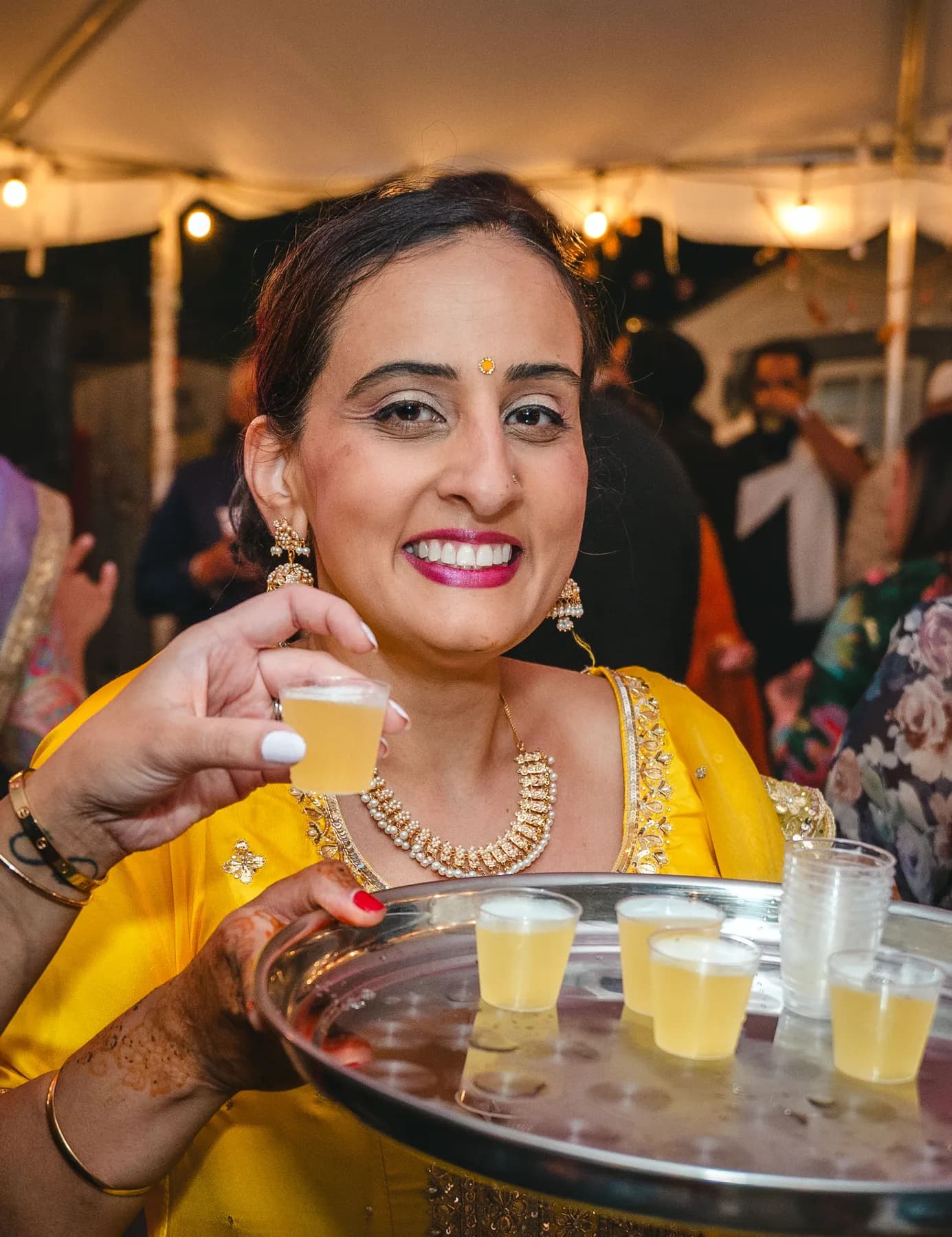 Guests dancing under evening lights at Aaron’s Haldi celebration.