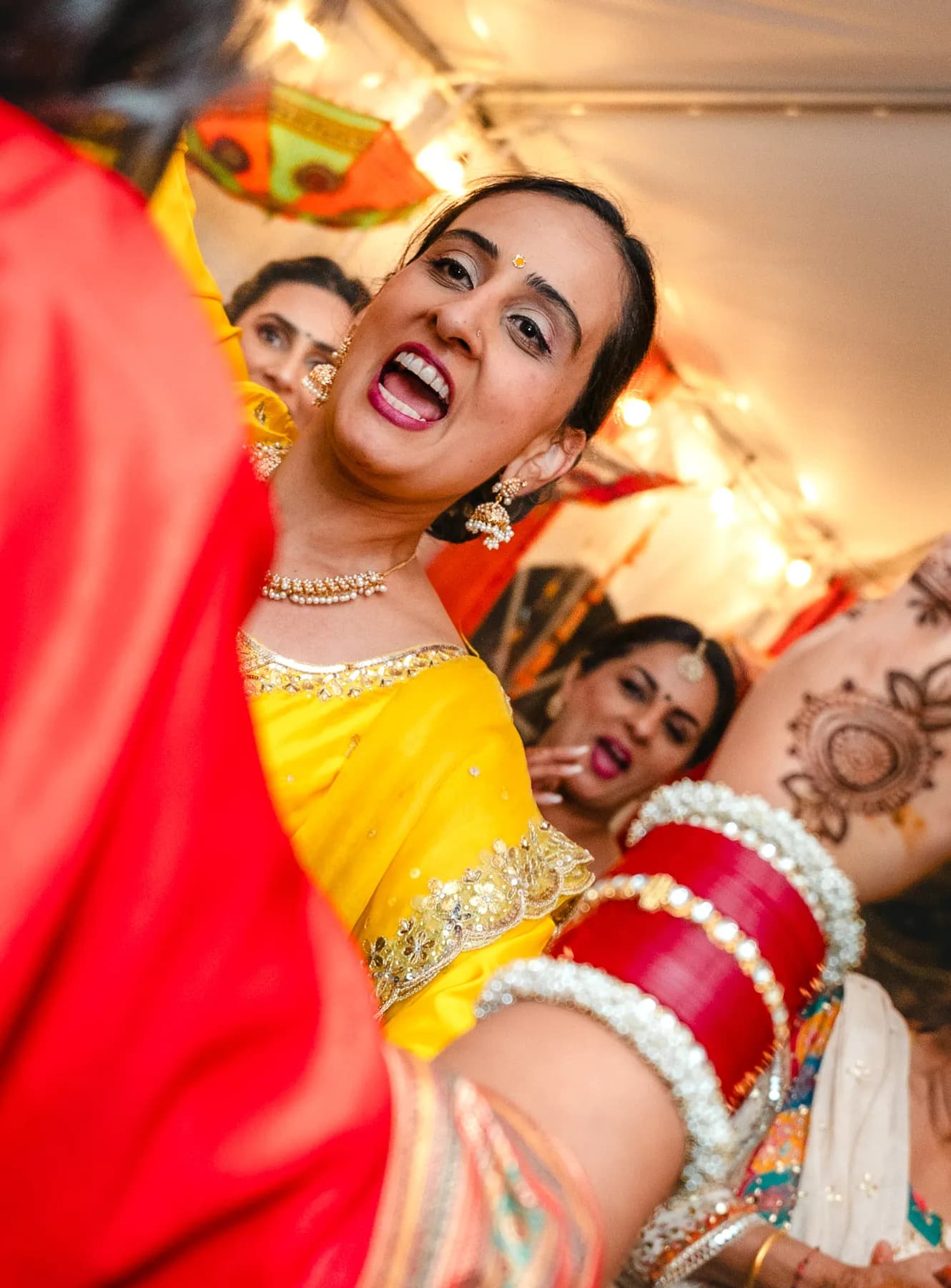 A woman dancing at Aaron’s Haldi celebration.