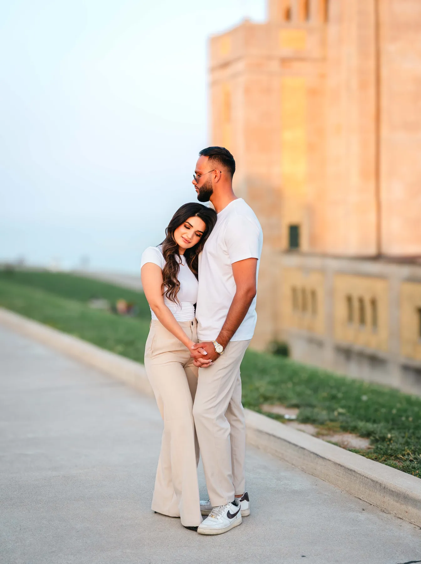 The couple posing outside a city building at A and F’s couples session.