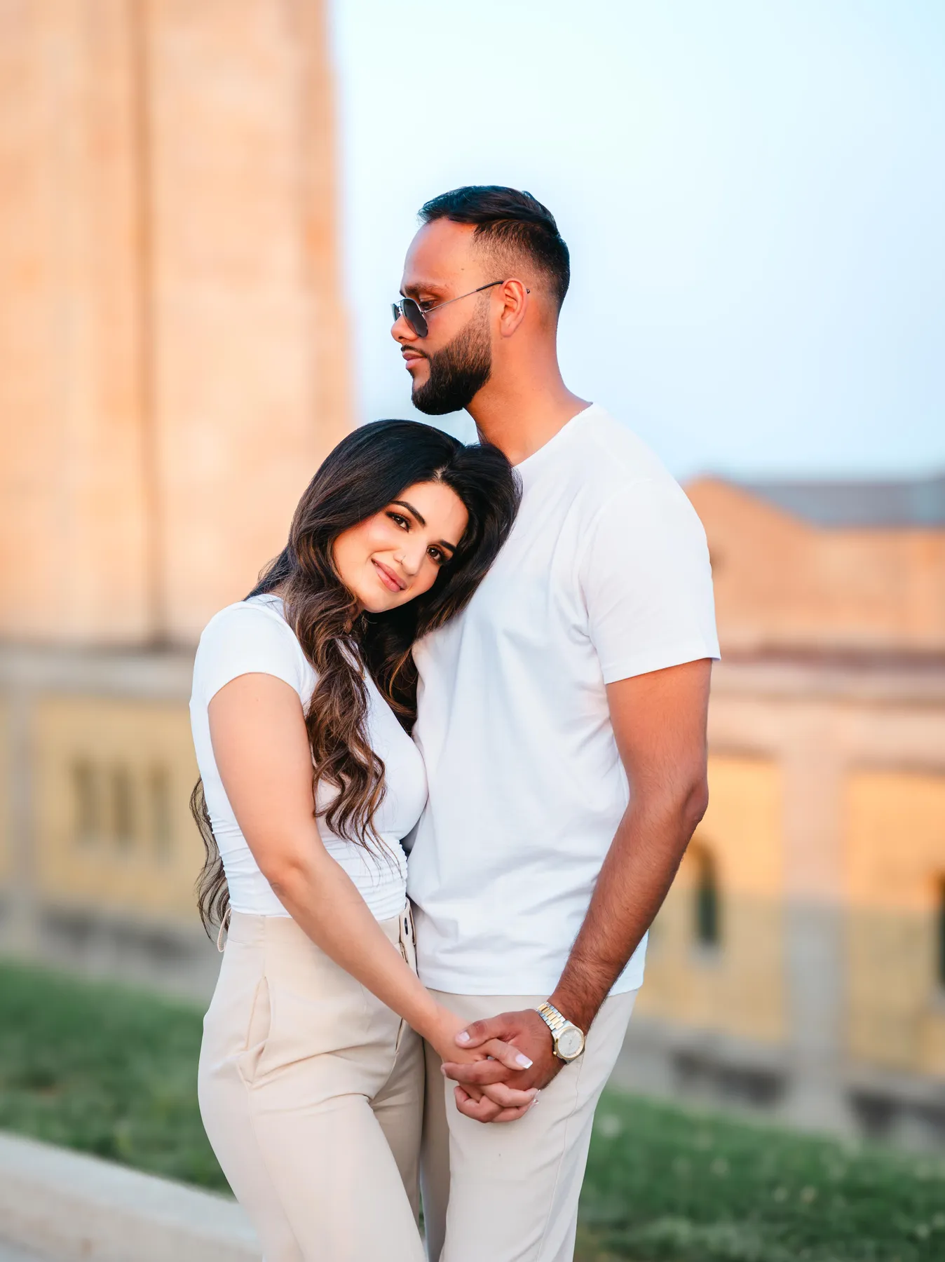 The couple posing outside a city building at A and F’s couples session.