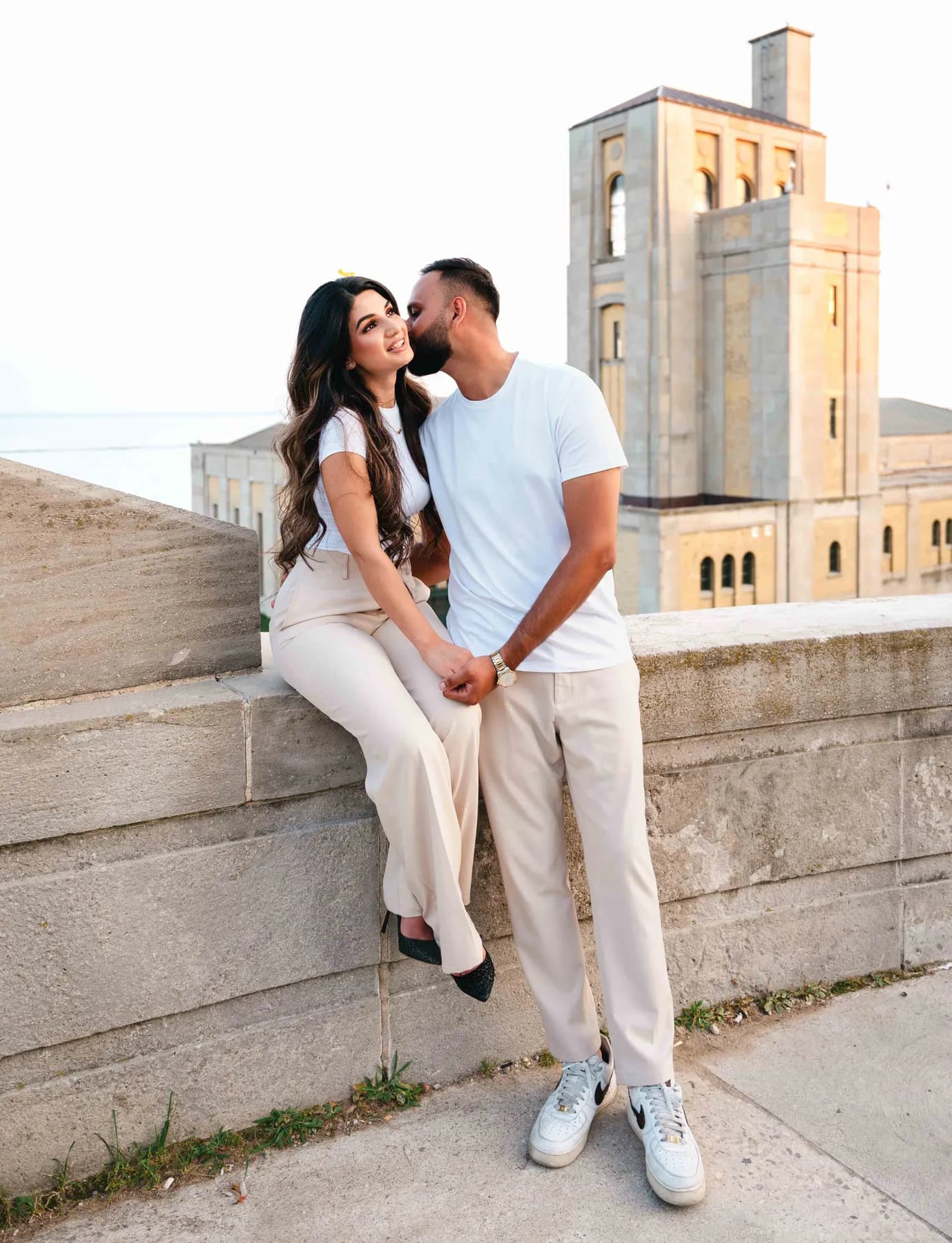 The couple together beside the seawall at A and F’s couples session.