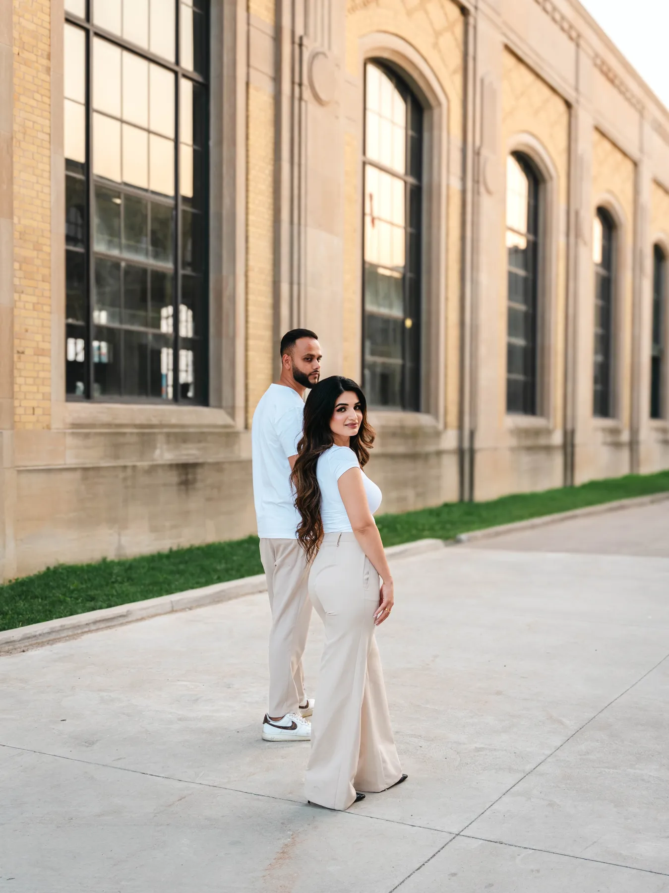 The couple embracing outside a city building at A and F’s couples session.