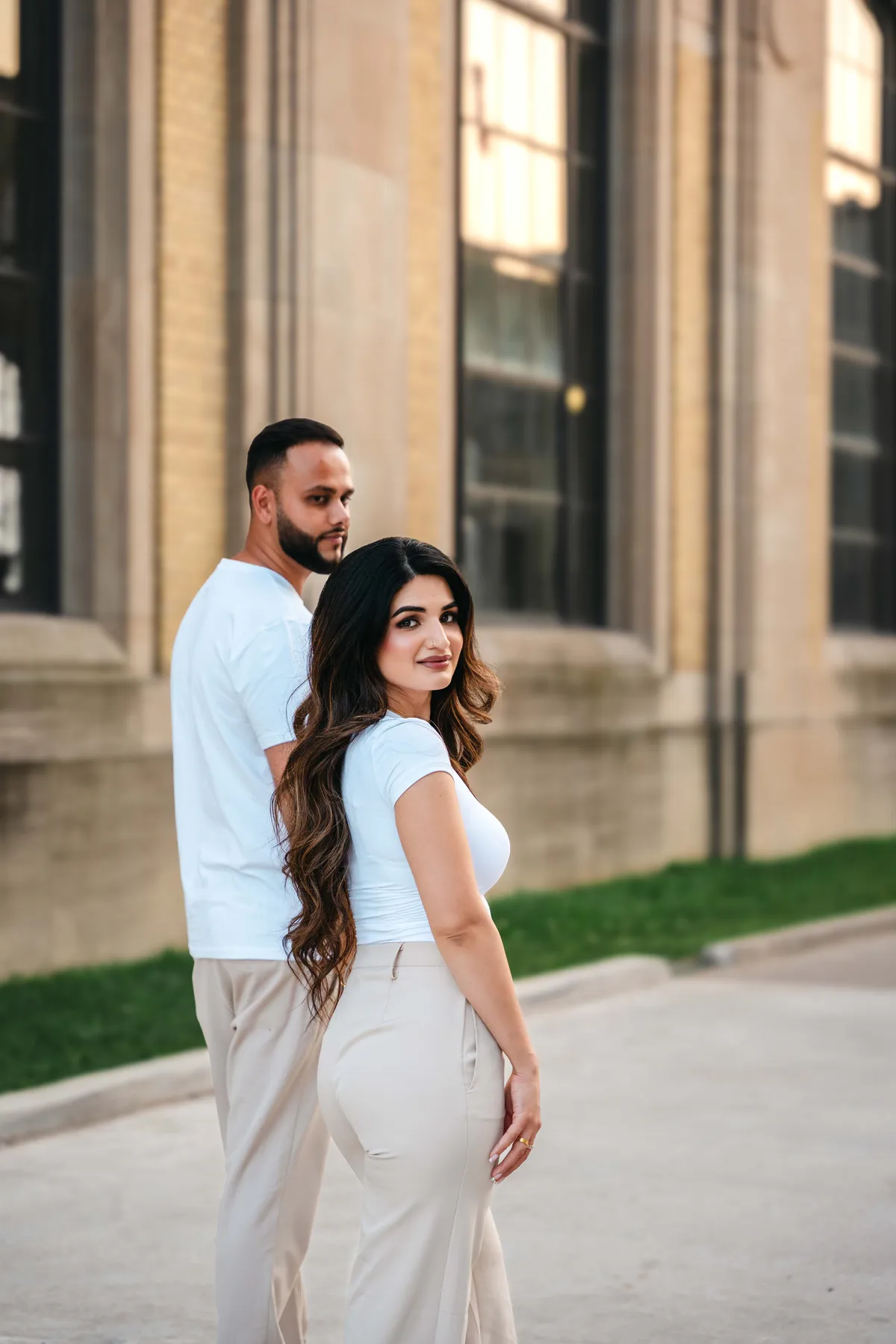 The couple embracing outside a city building at A and F’s couples session.