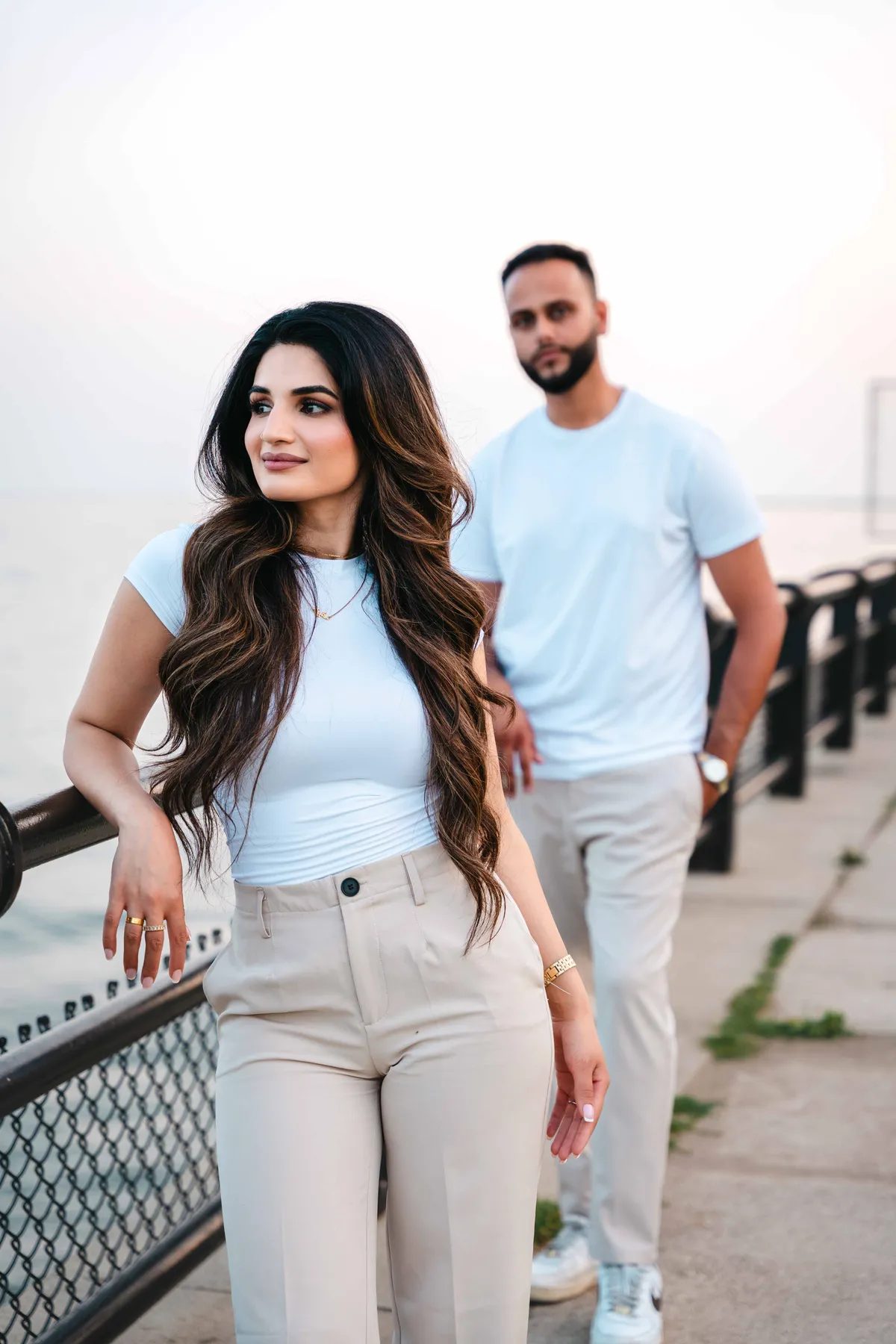 The couple beside a waterfront railing at A and F’s couples session.