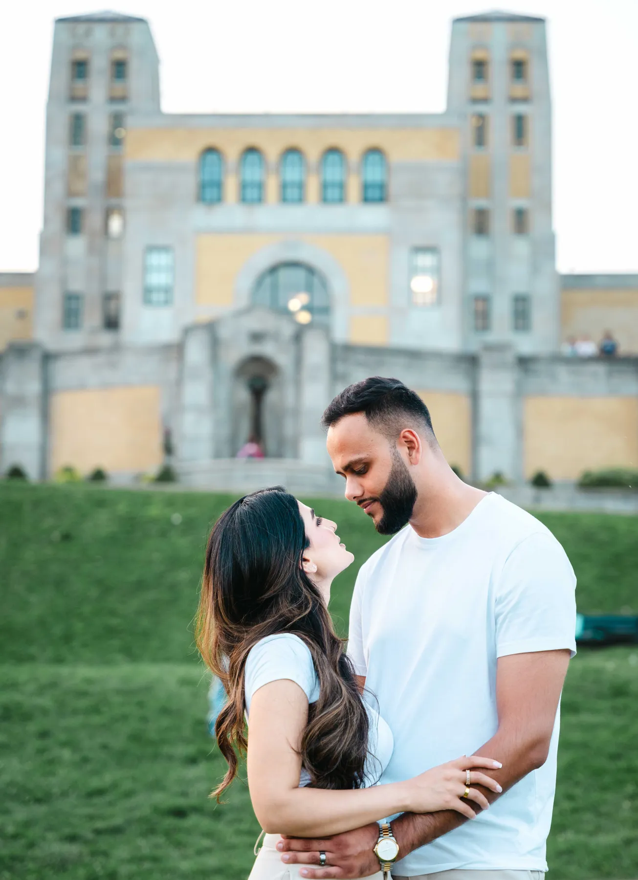 The couple embracing outside a building at A and F’s couples session.