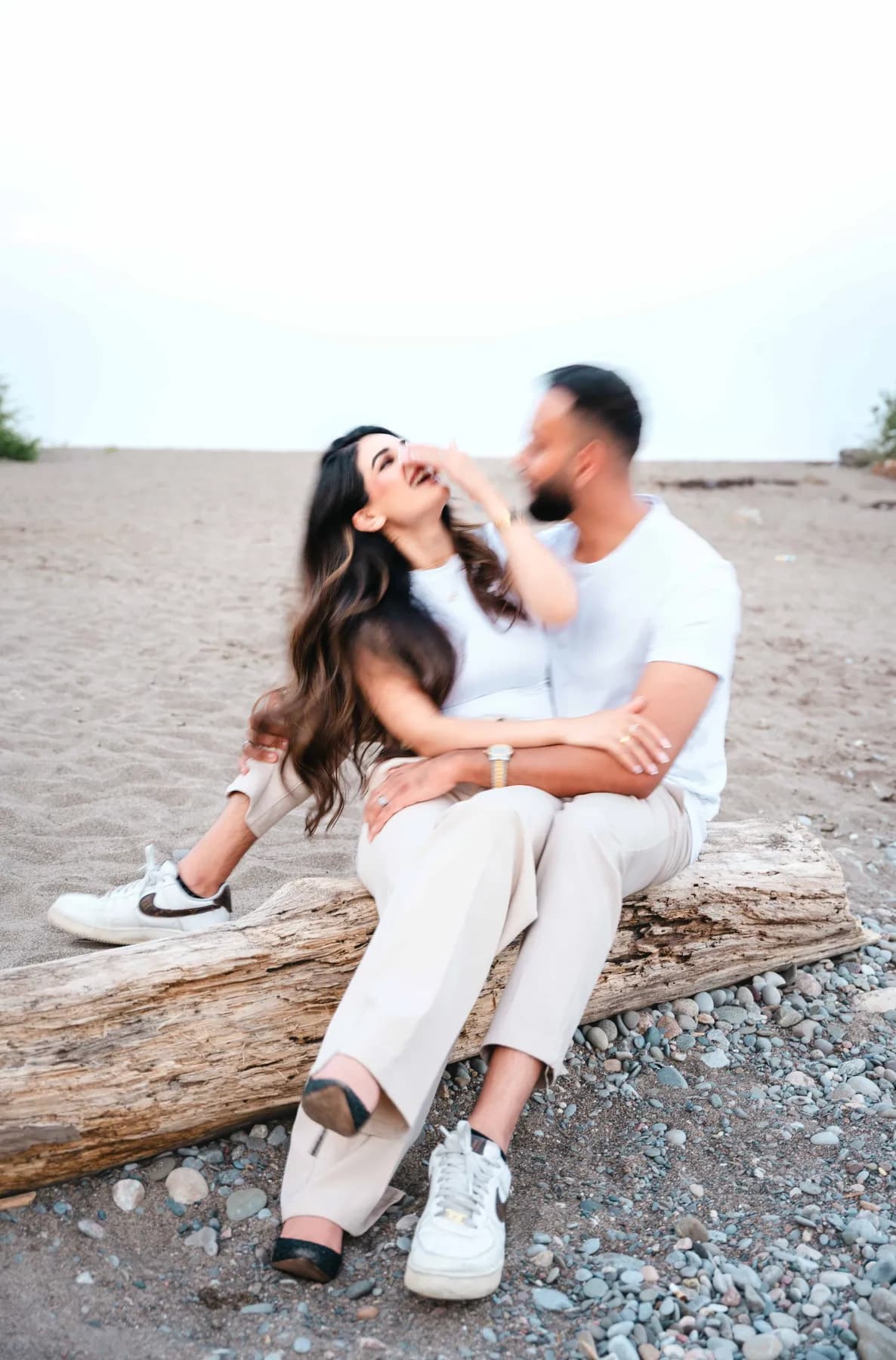 The couple seated together on the beach at A and F’s couples session.
