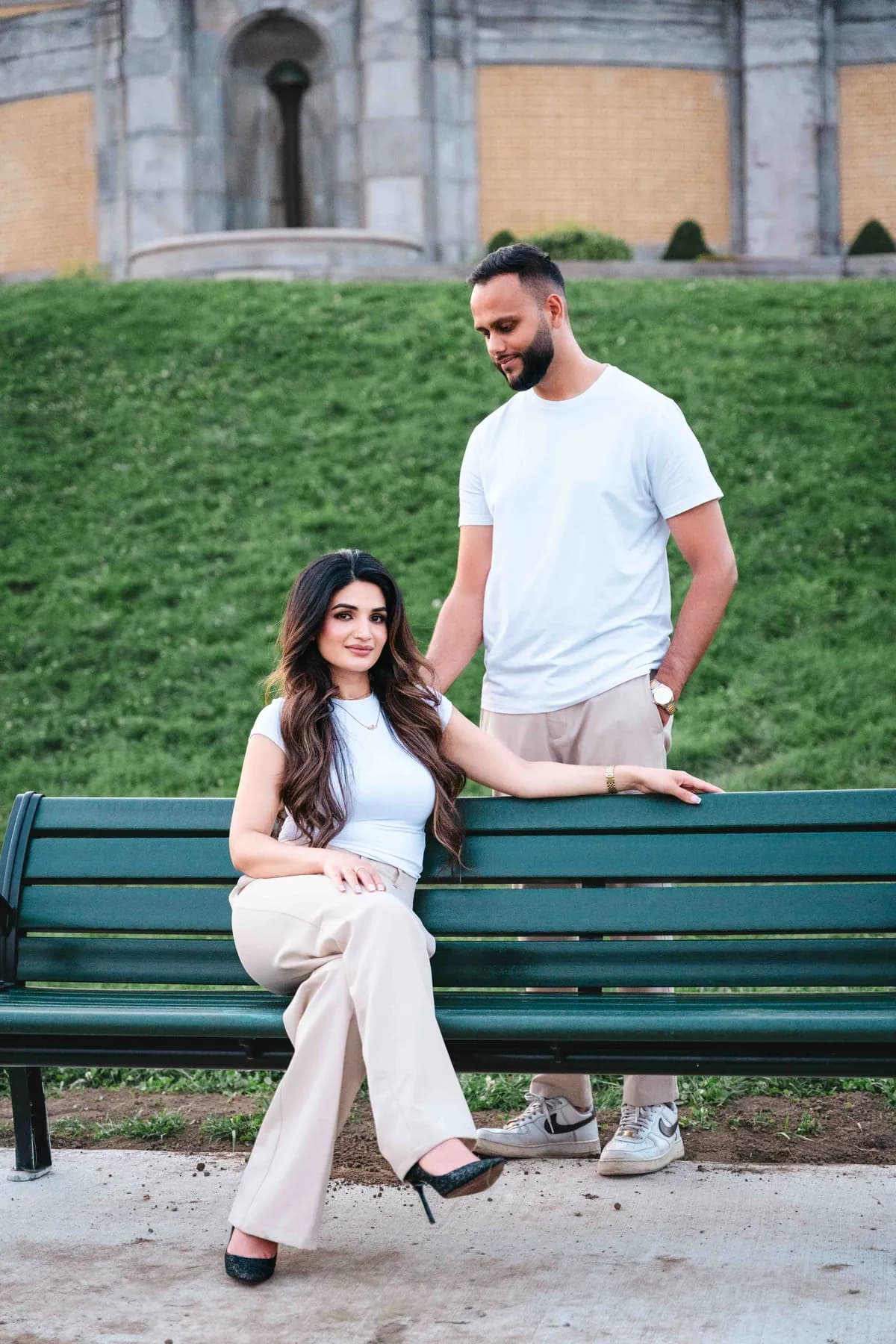 The couple beside a park bench at A and F’s couples session.