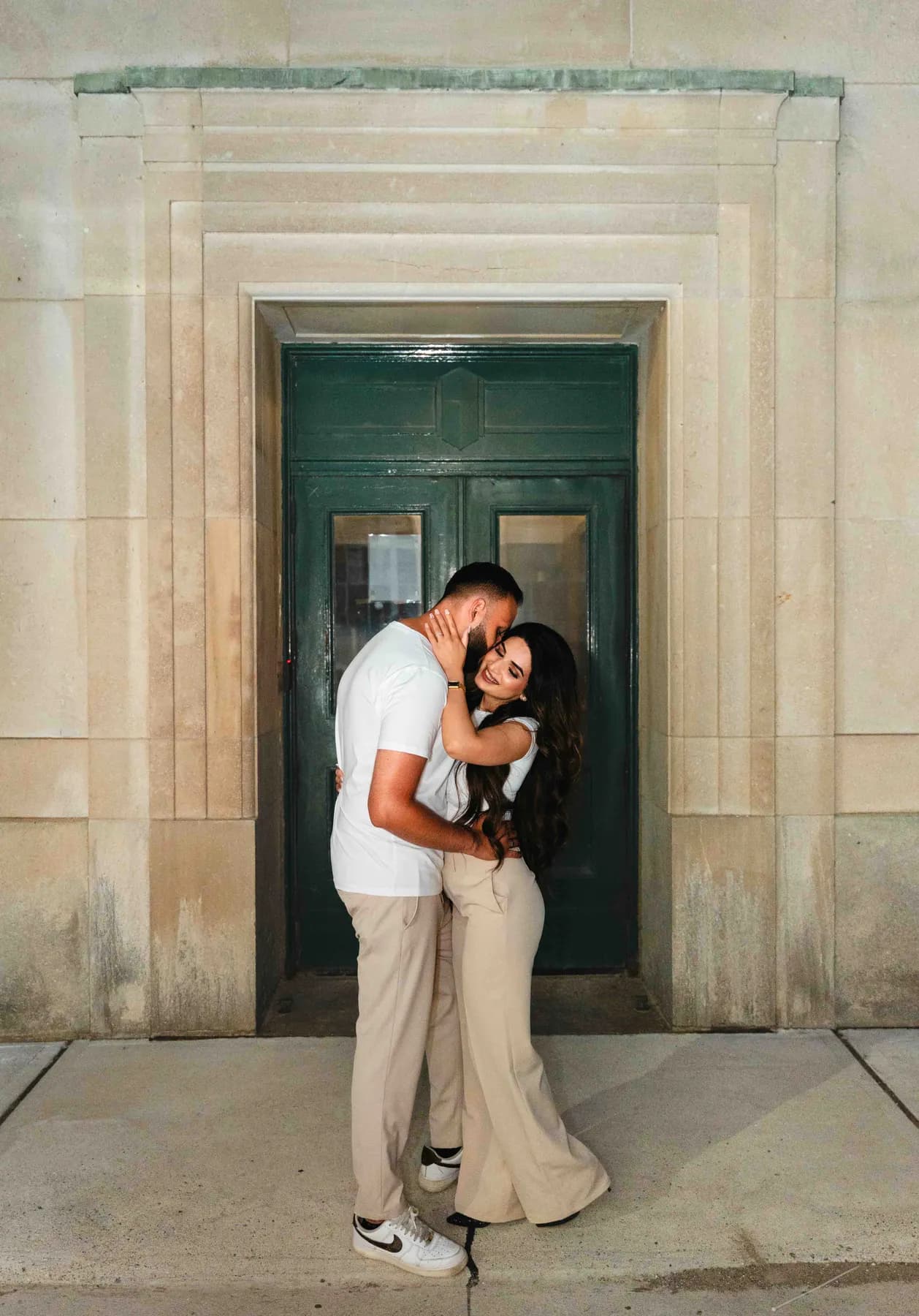 The couple embracing in a doorway at A and F’s couples session.