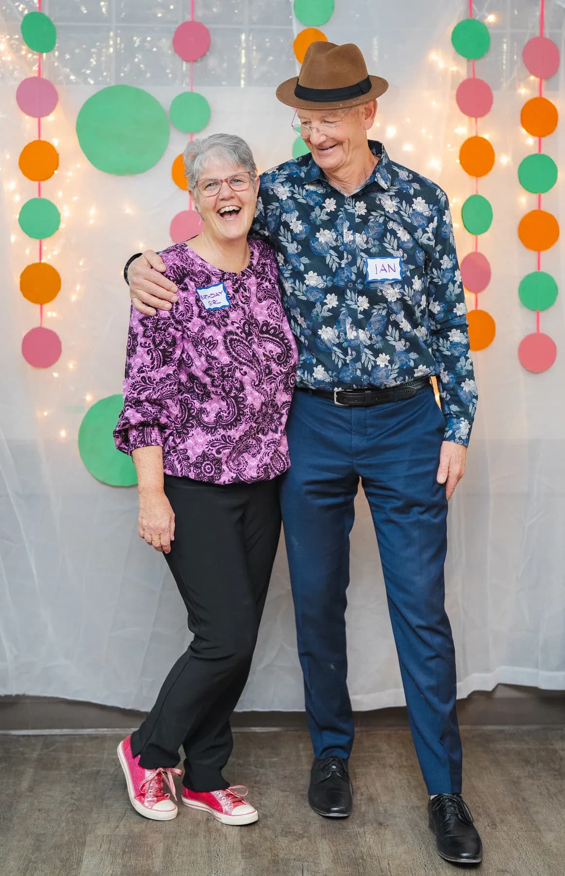 Two guests laughing and posing together at Alison’s birthday celebration.