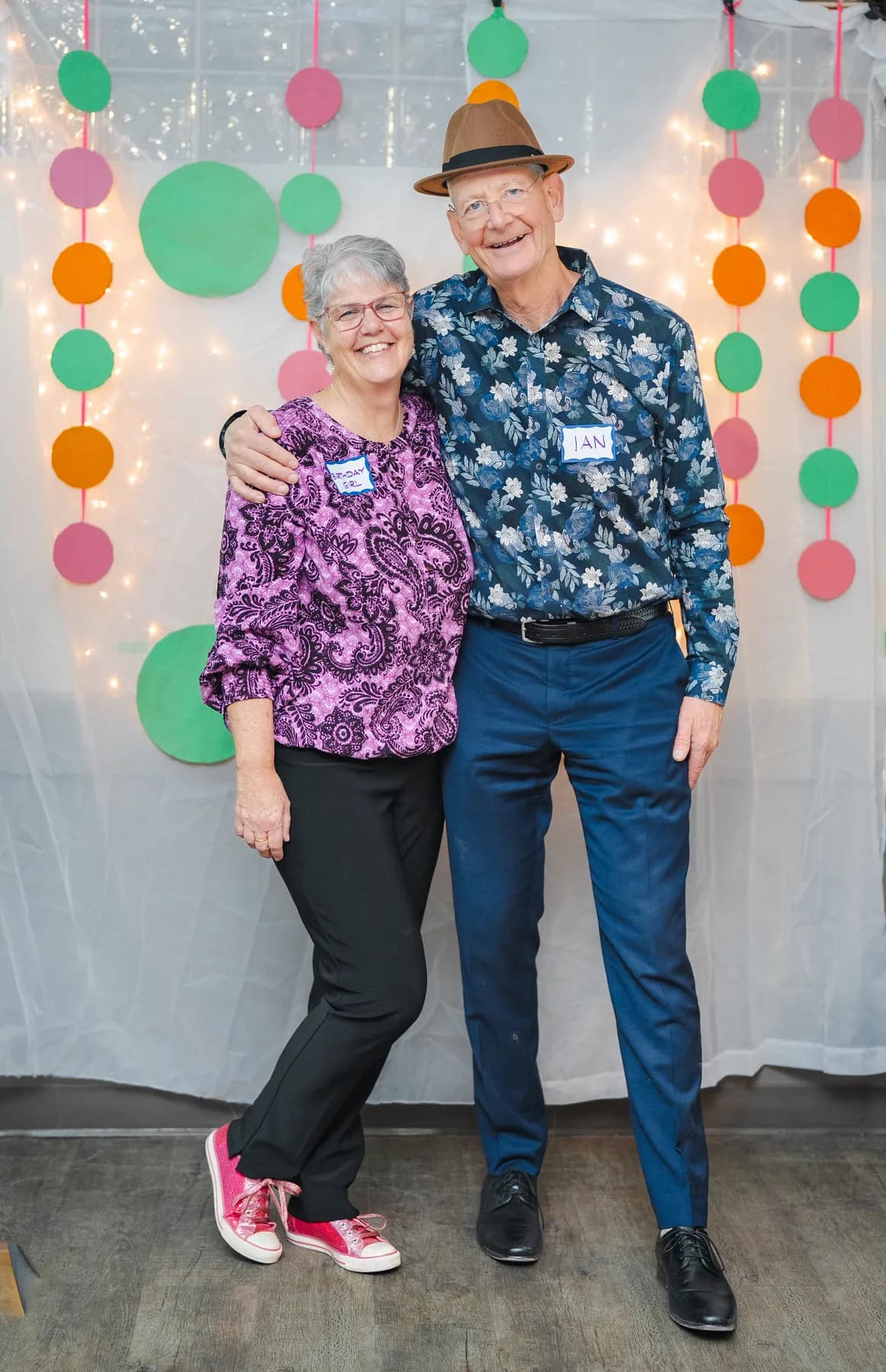 Two guests laughing and posing together at Alison’s birthday celebration.