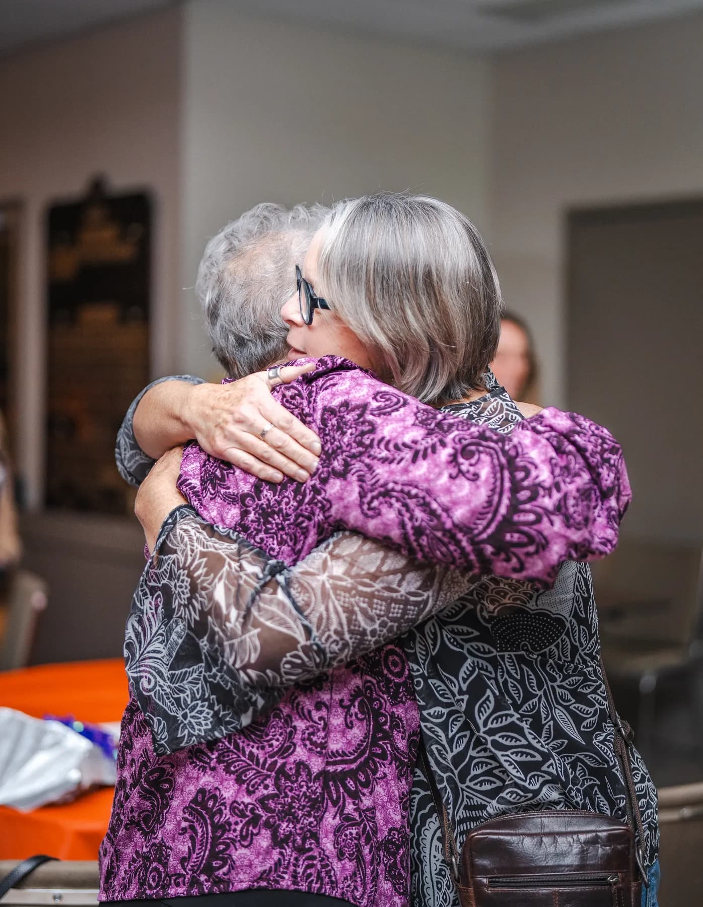 Guests sharing a hug at Alison’s birthday celebration.