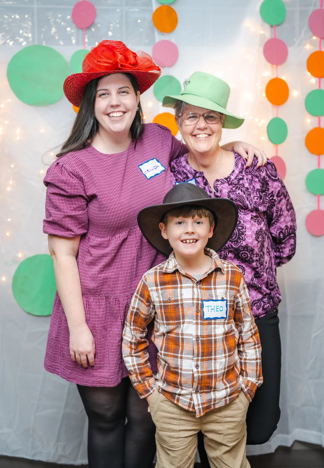 Guests posing in playful hats at Alison’s birthday celebration.