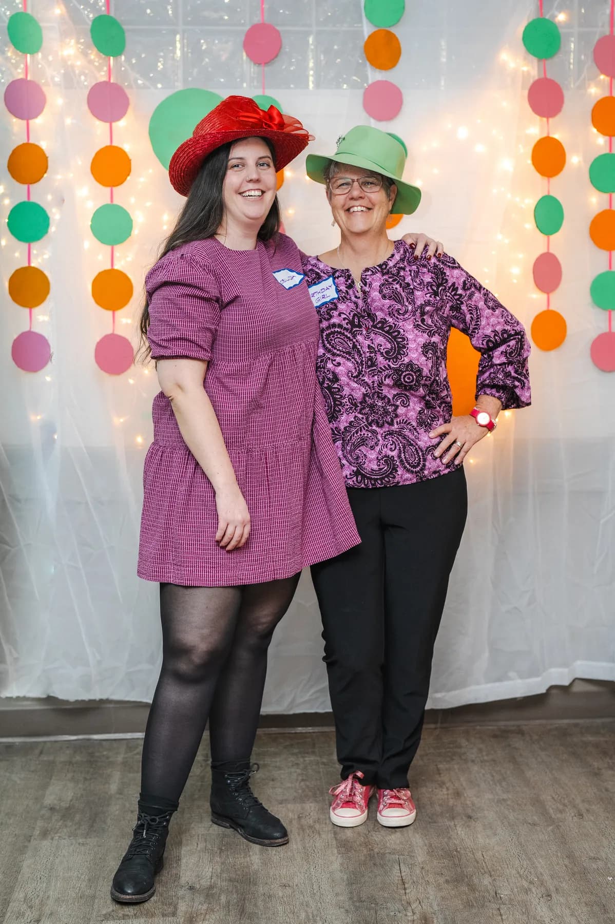 Guests posing in playful hats at Alison’s birthday celebration.