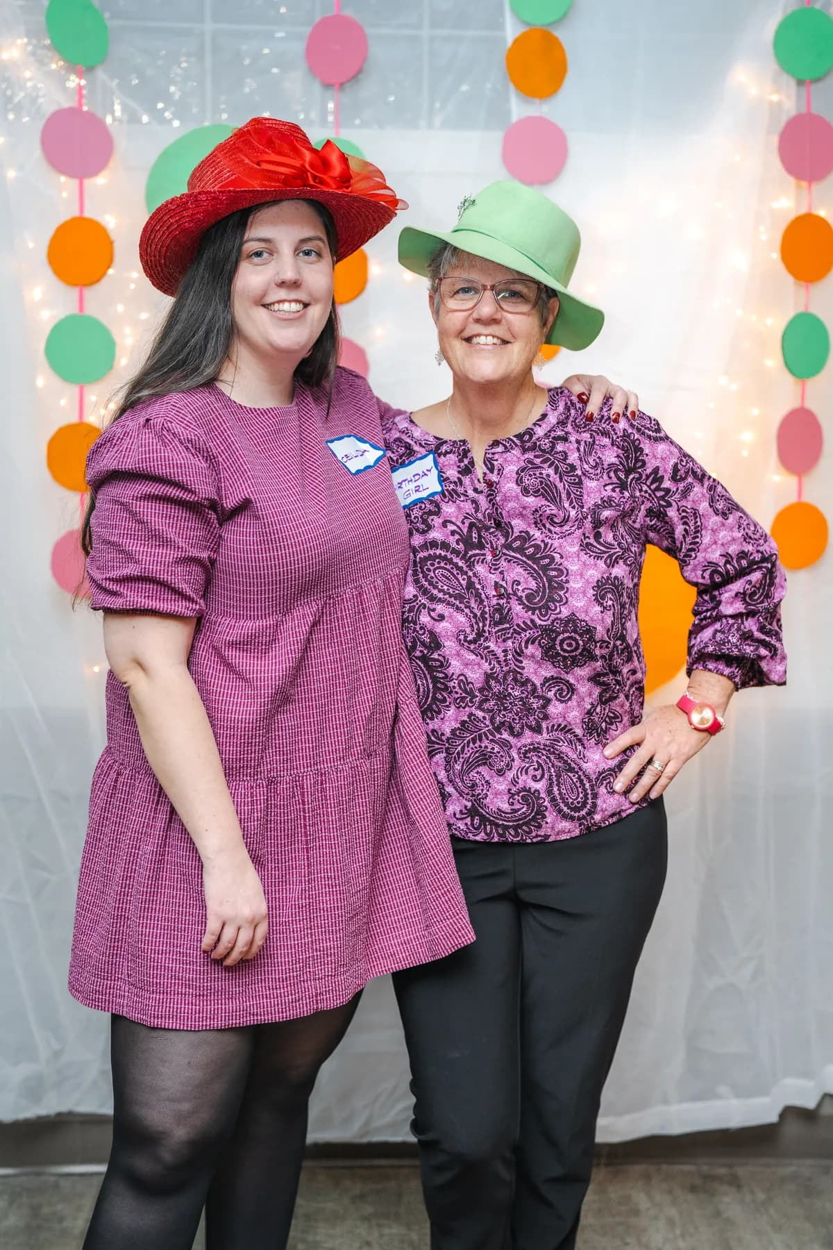 Guests posing in playful hats at Alison’s birthday celebration.
