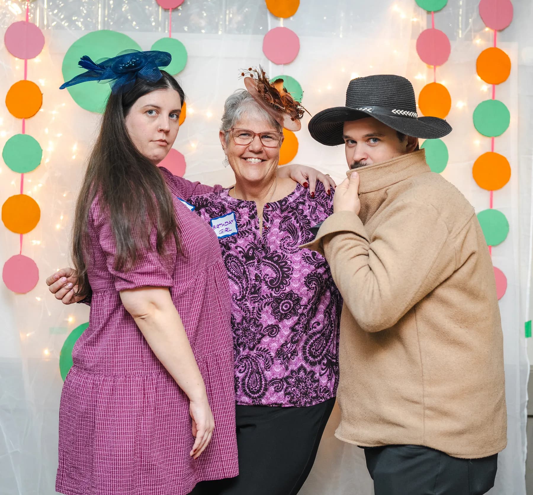 Guests posing in playful hats at Alison’s birthday celebration.