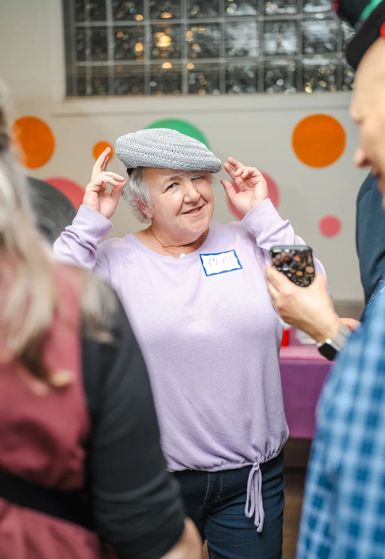 Guests wearing playful hats at Alison’s birthday celebration.