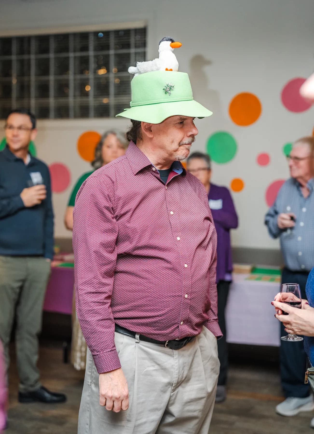 Guests wearing playful hats at Alison’s birthday celebration.
