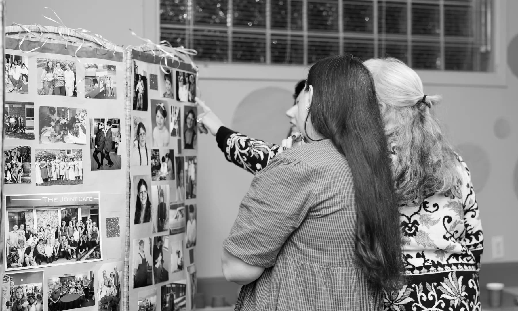 Guests looking at a photograph display at Alison’s birthday celebration.