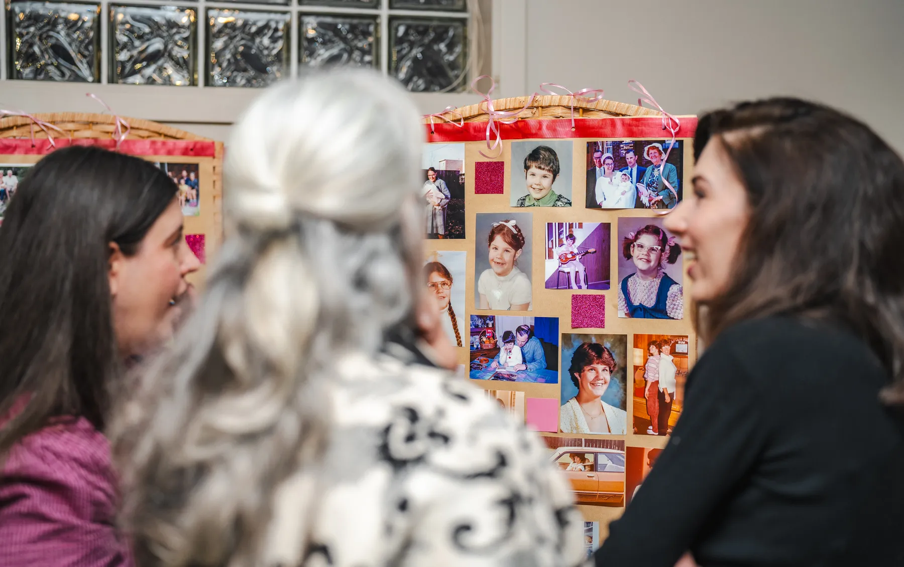 Guests looking at a photograph display at Alison’s birthday celebration.