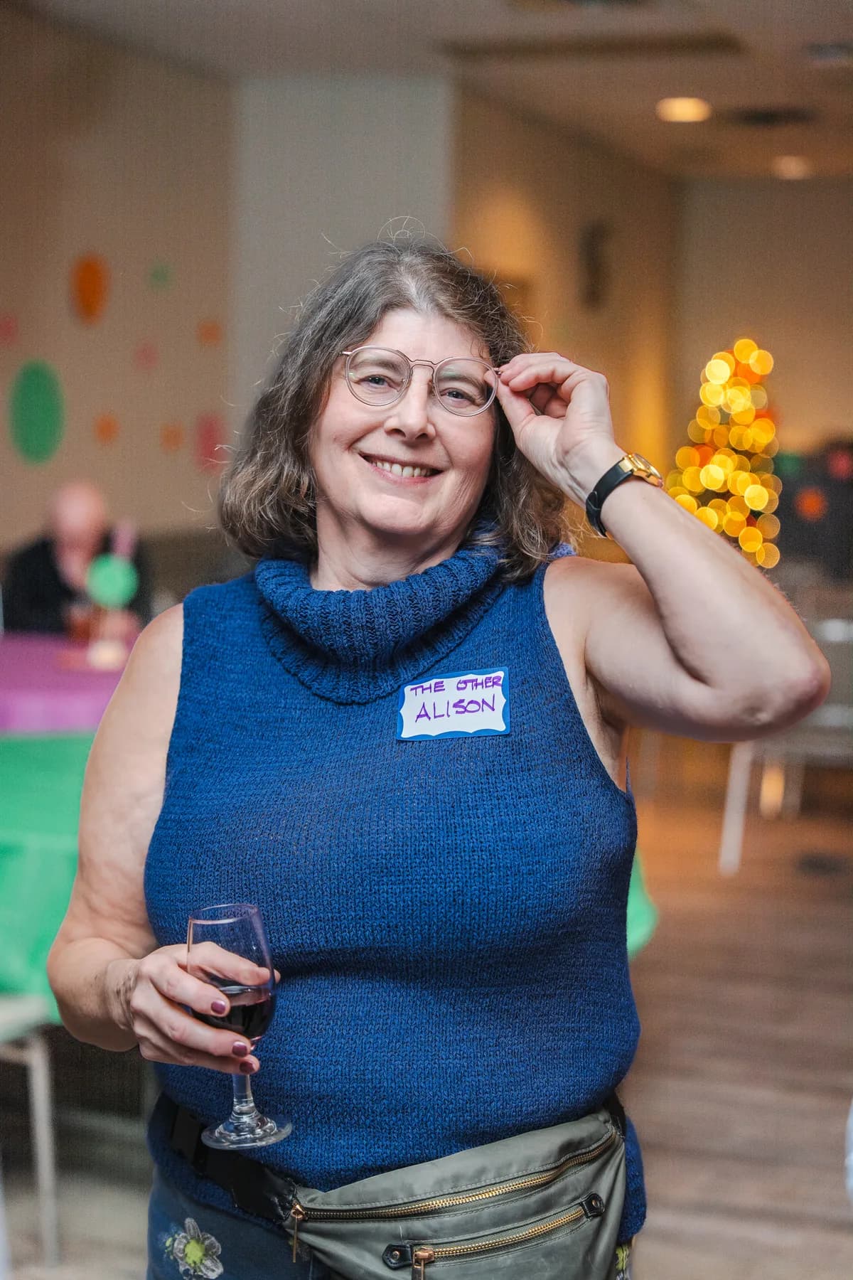 A woman smiling at Alison’s birthday celebration.