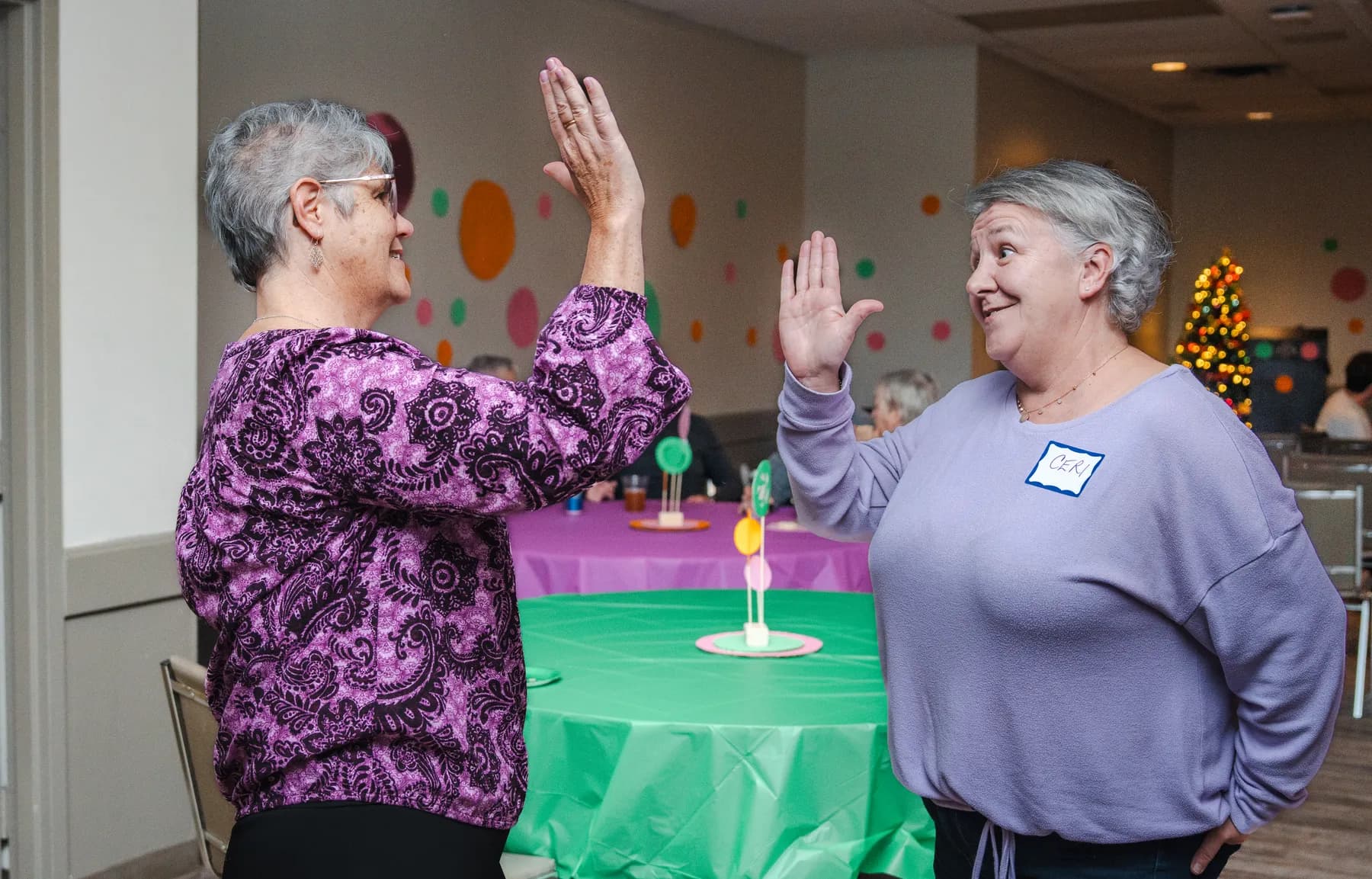 Two guests sharing a high five at Alison’s birthday celebration.