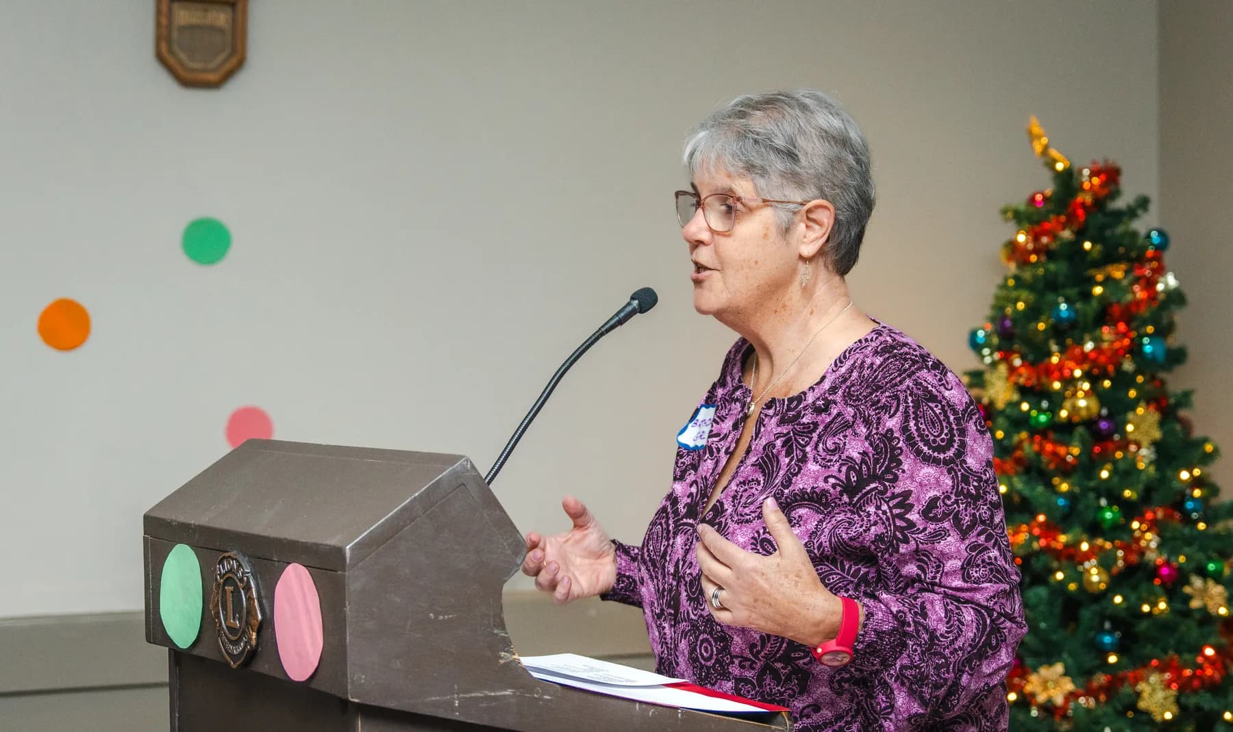 A woman speaking at the lectern at Alison’s birthday celebration.