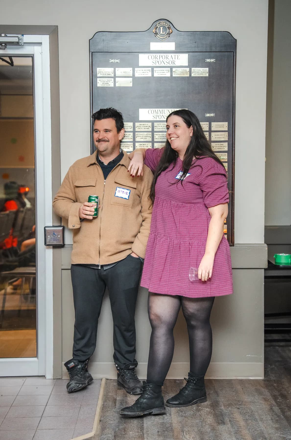 A couple posing in the entryway at Alison’s birthday celebration.