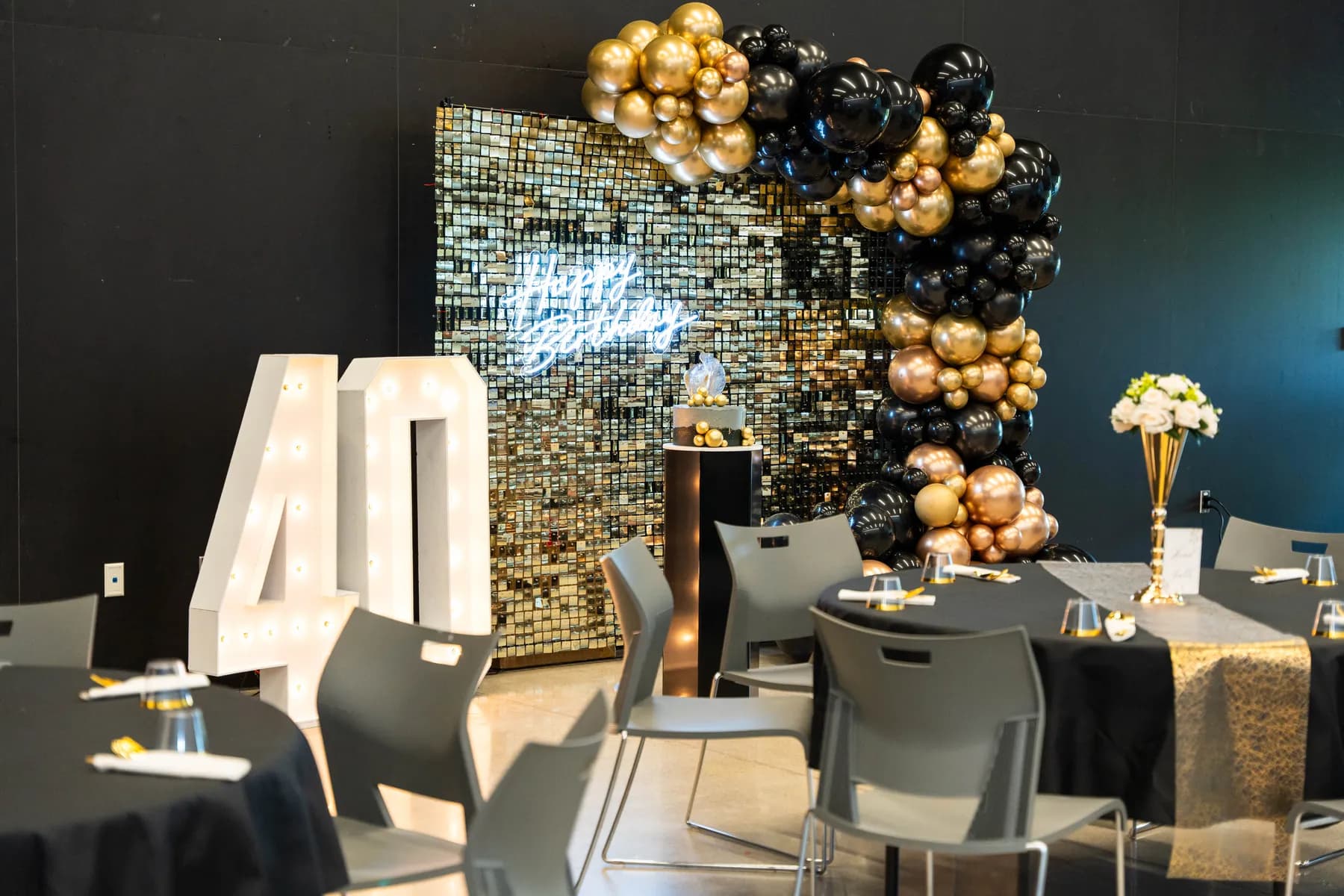 Party tables and black and gold decorations at BJ’s 40th birthday party.