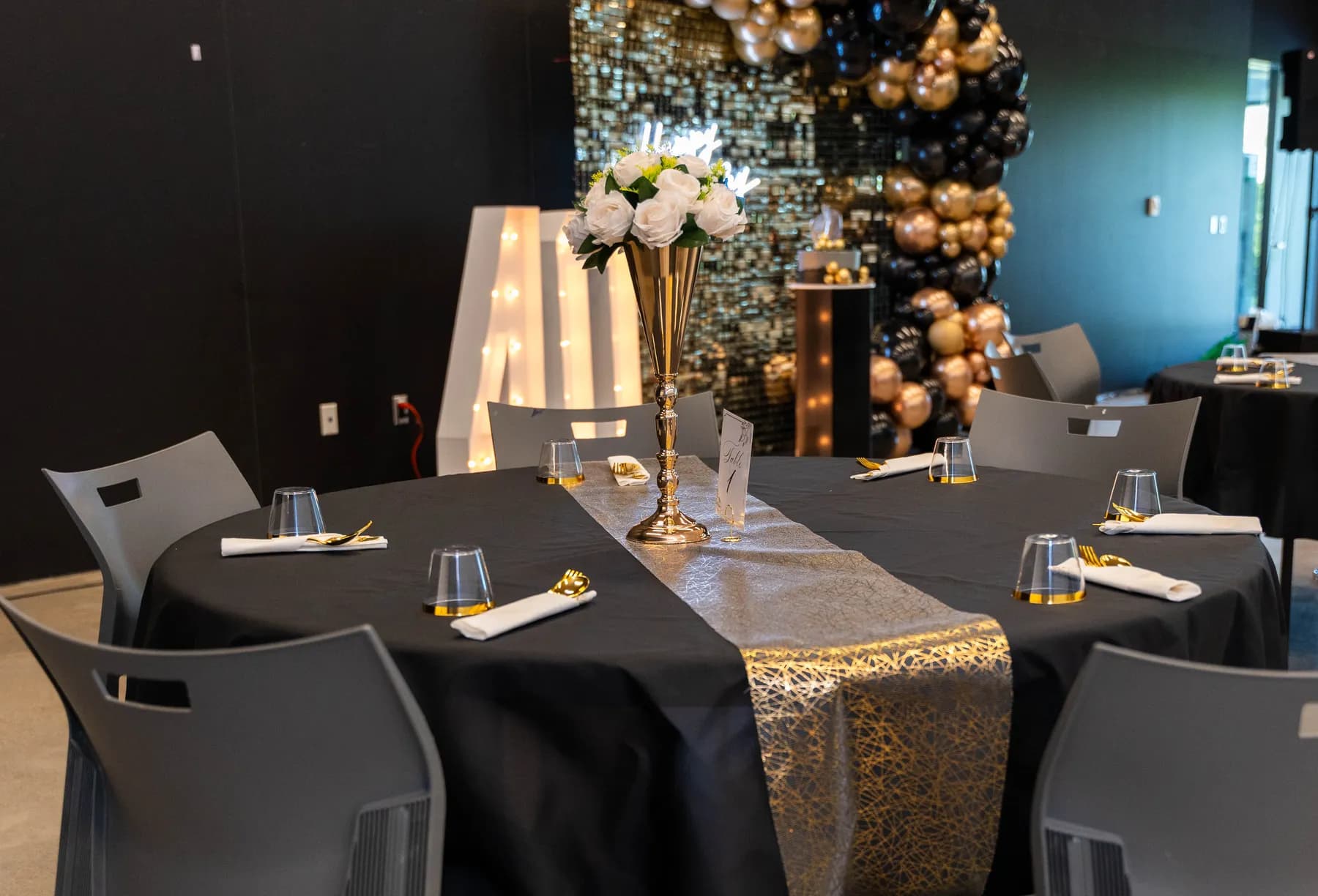 Party tables and black and gold decorations at BJ’s 40th birthday party.