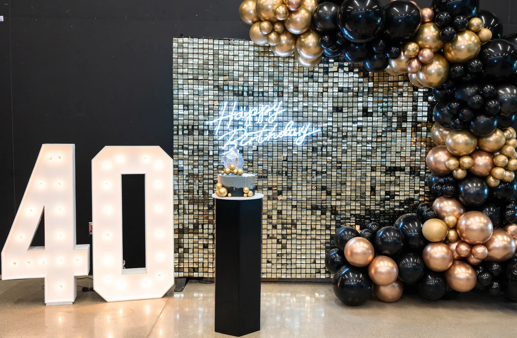 Party tables and black and gold decorations at BJ’s 40th birthday party.
