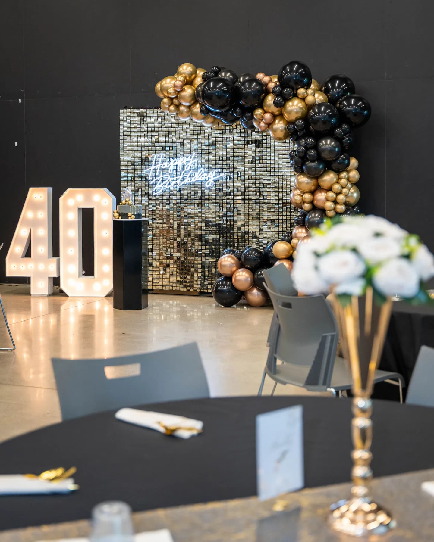 Party tables and black and gold decorations at BJ’s 40th birthday party.