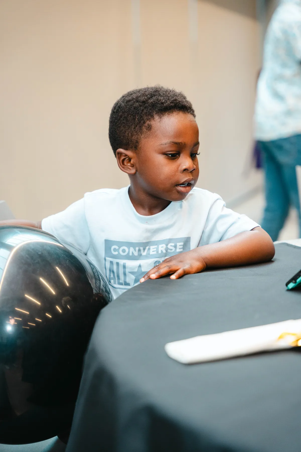 A child at a party table at BJ’s 40th birthday party.