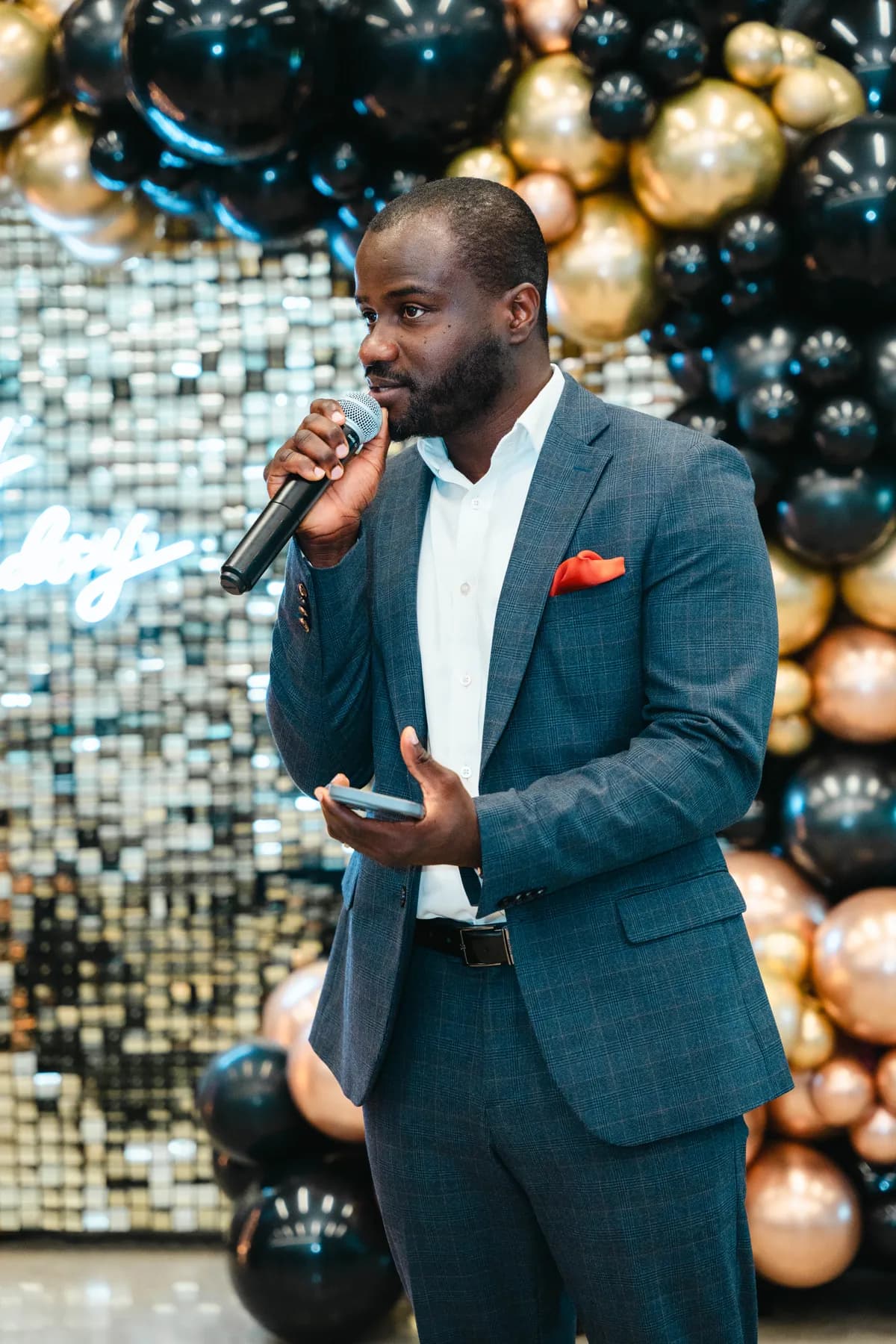 A guest speaking into a microphone at BJ’s 40th birthday party.