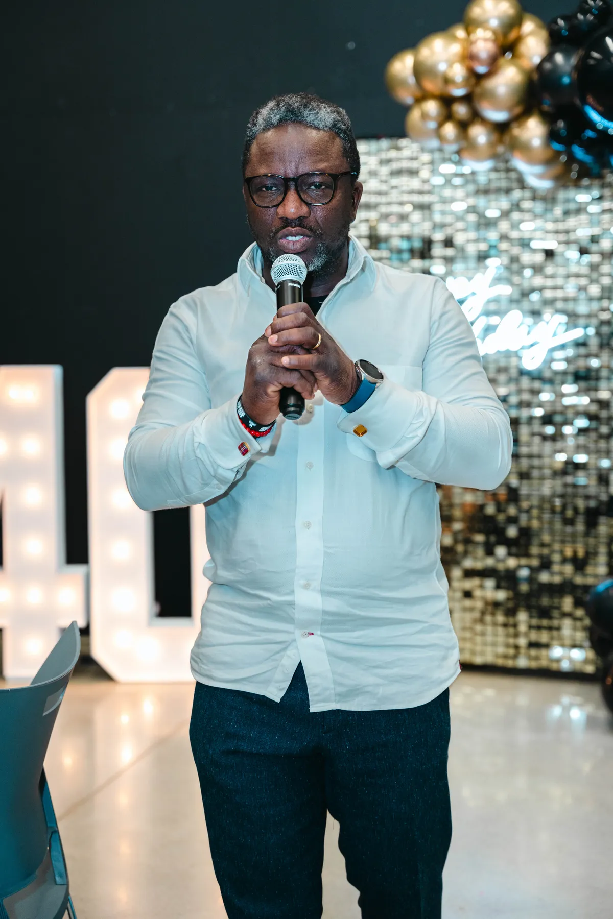 A guest speaking into a microphone at BJ’s 40th birthday party.