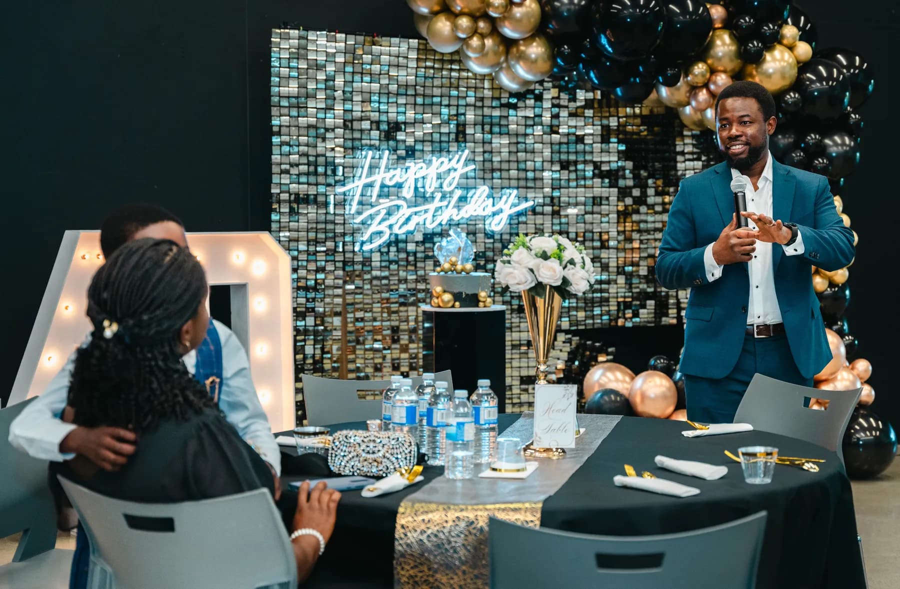 A man addressing the party guests at BJ’s 40th birthday party.