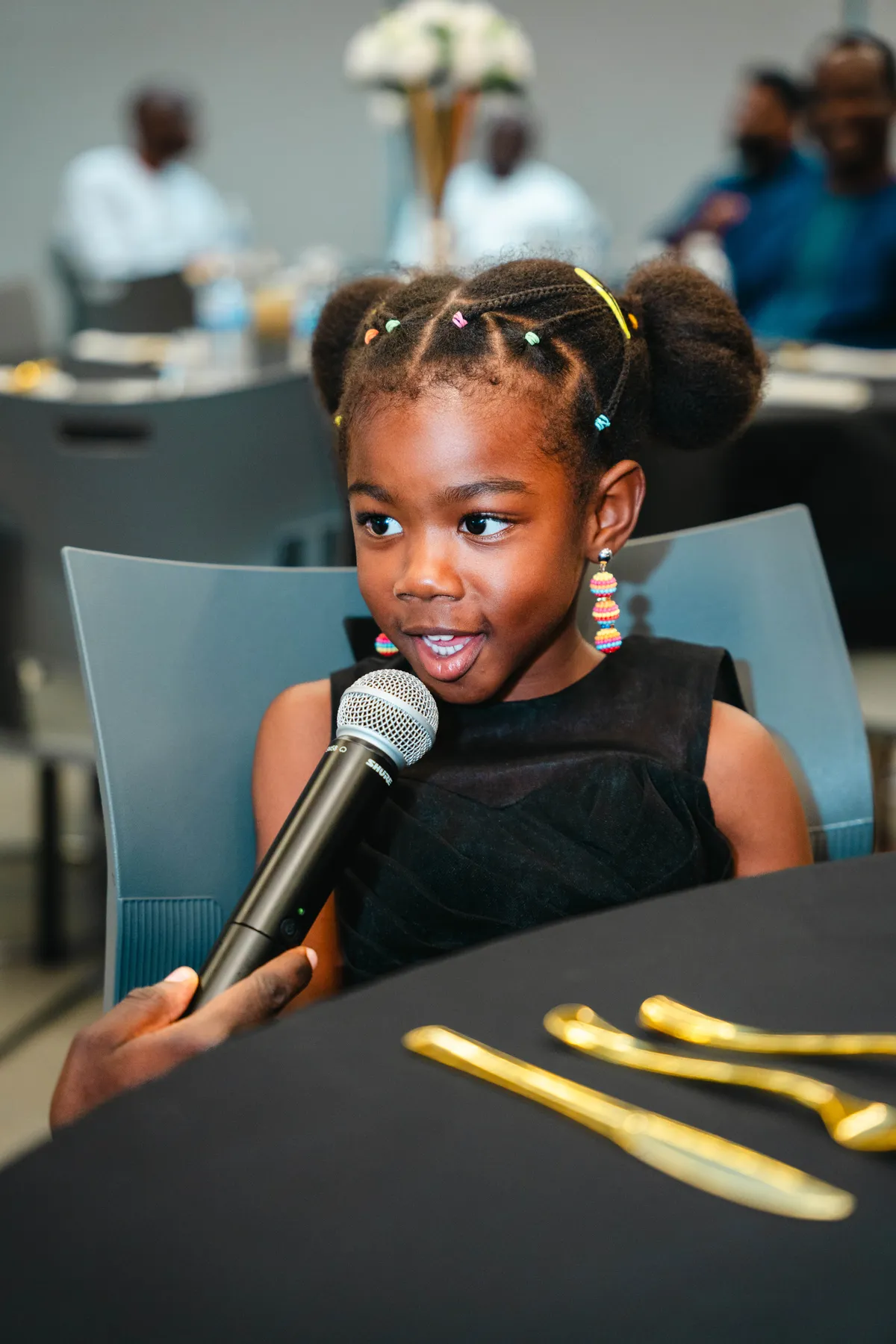 A child speaking into a microphone at BJ’s 40th birthday party.