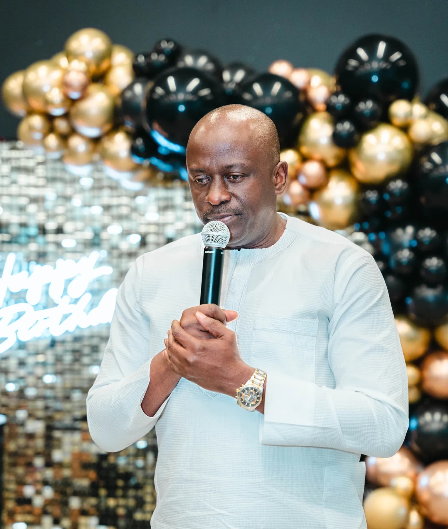A guest speaking into a microphone at BJ’s 40th birthday party.