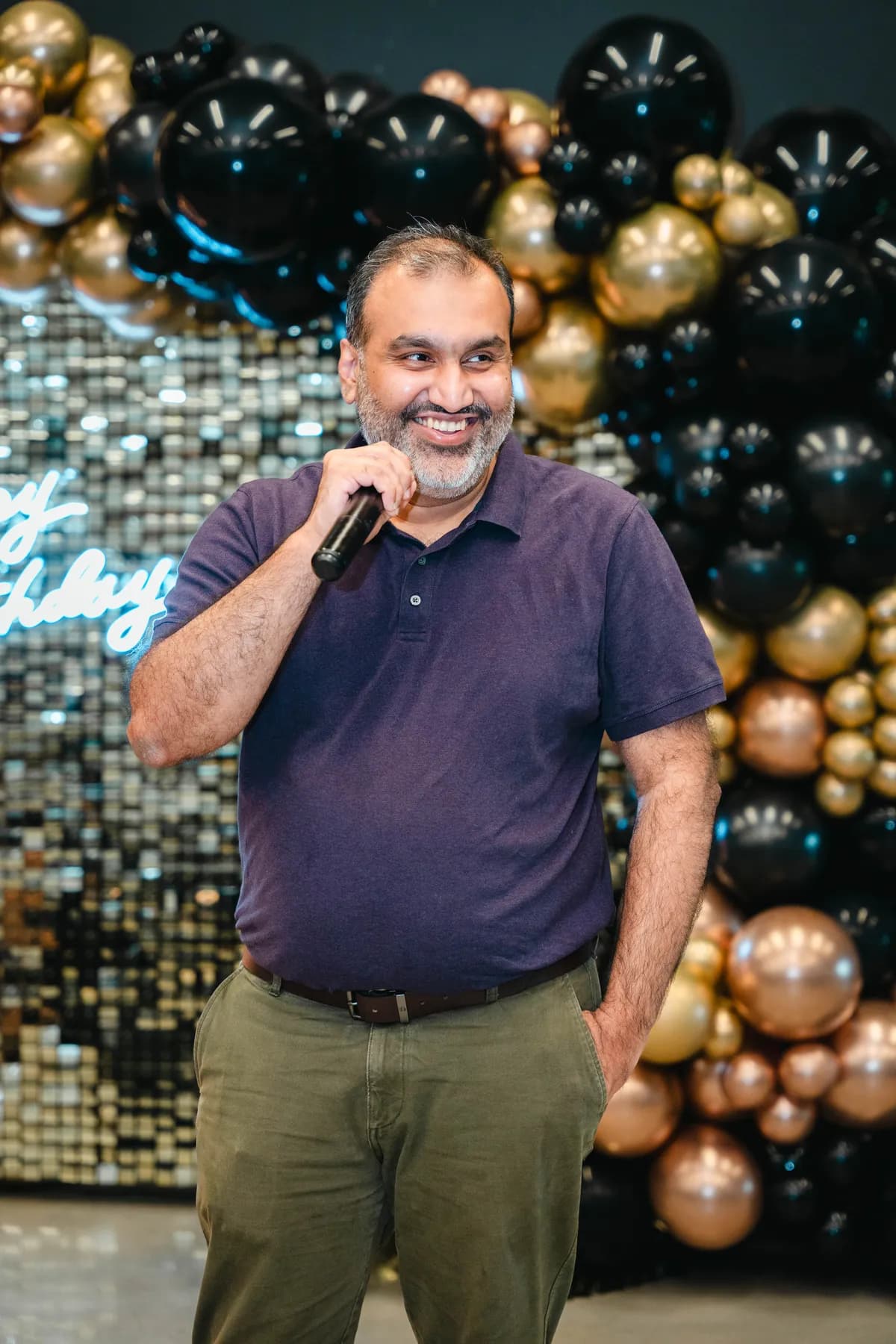 A guest speaking into a microphone at BJ’s 40th birthday party.