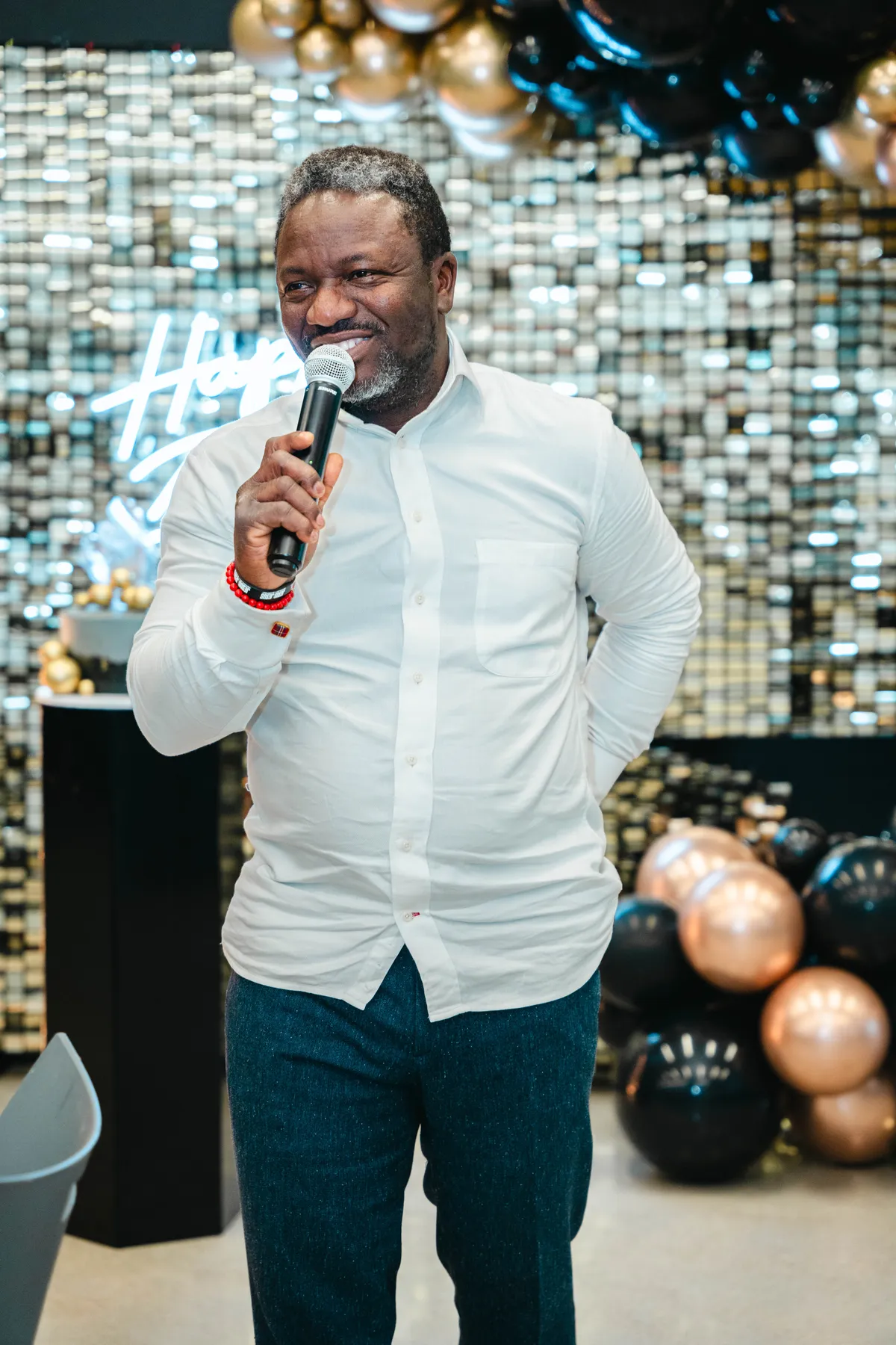 A guest speaking into a microphone at BJ’s 40th birthday party.