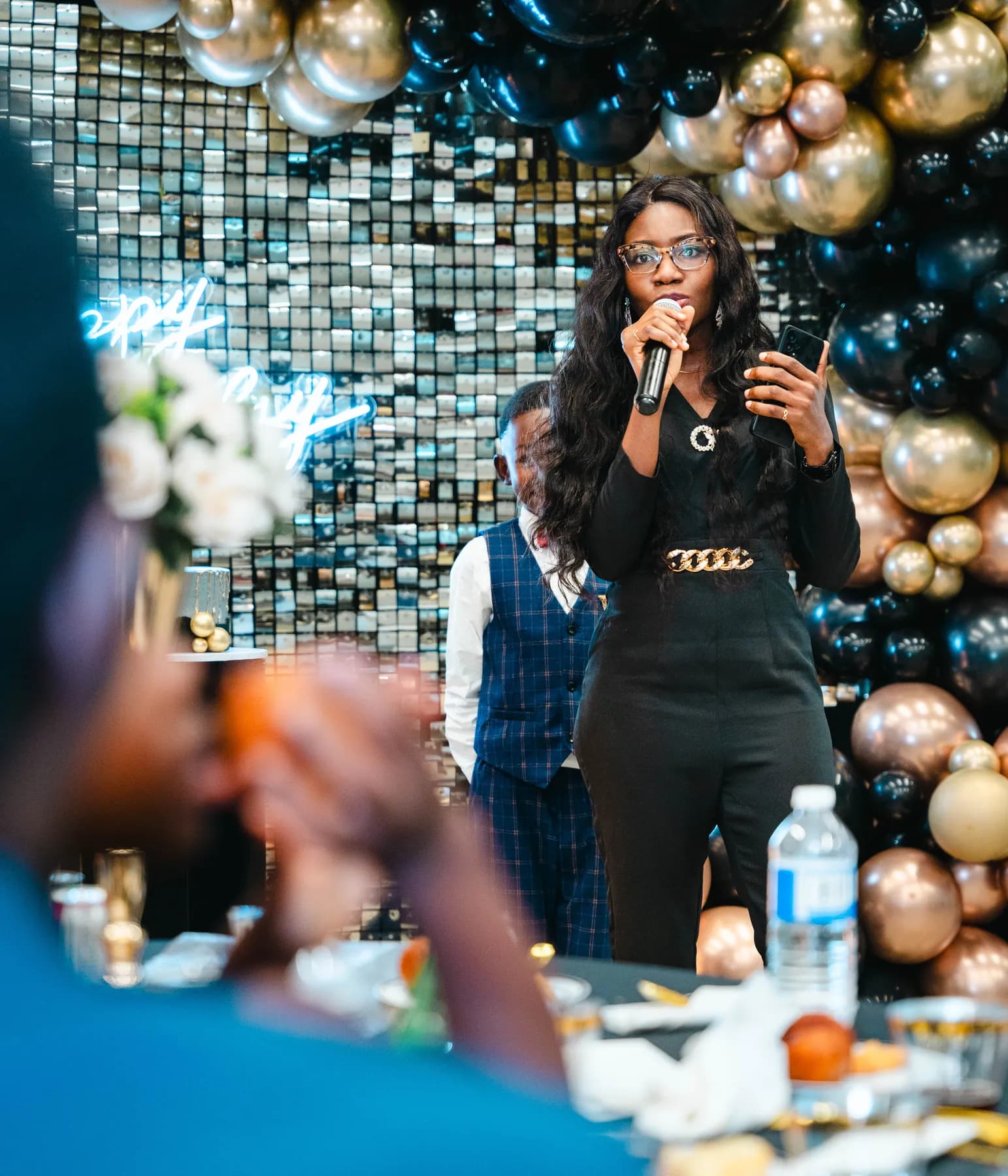 A guest speaking into a microphone at BJ’s 40th birthday party.