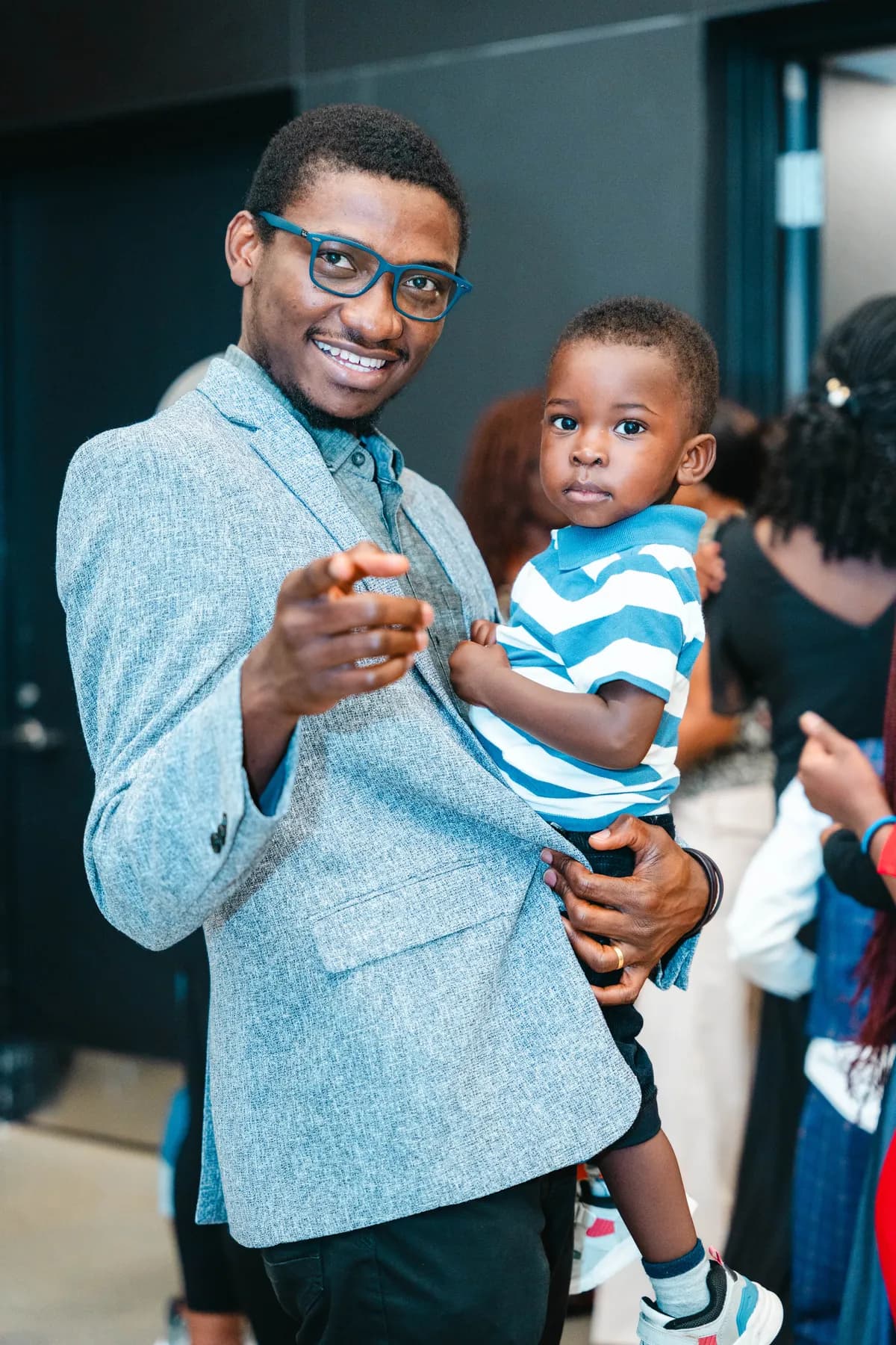 A man holding a child at BJ’s 40th birthday party.