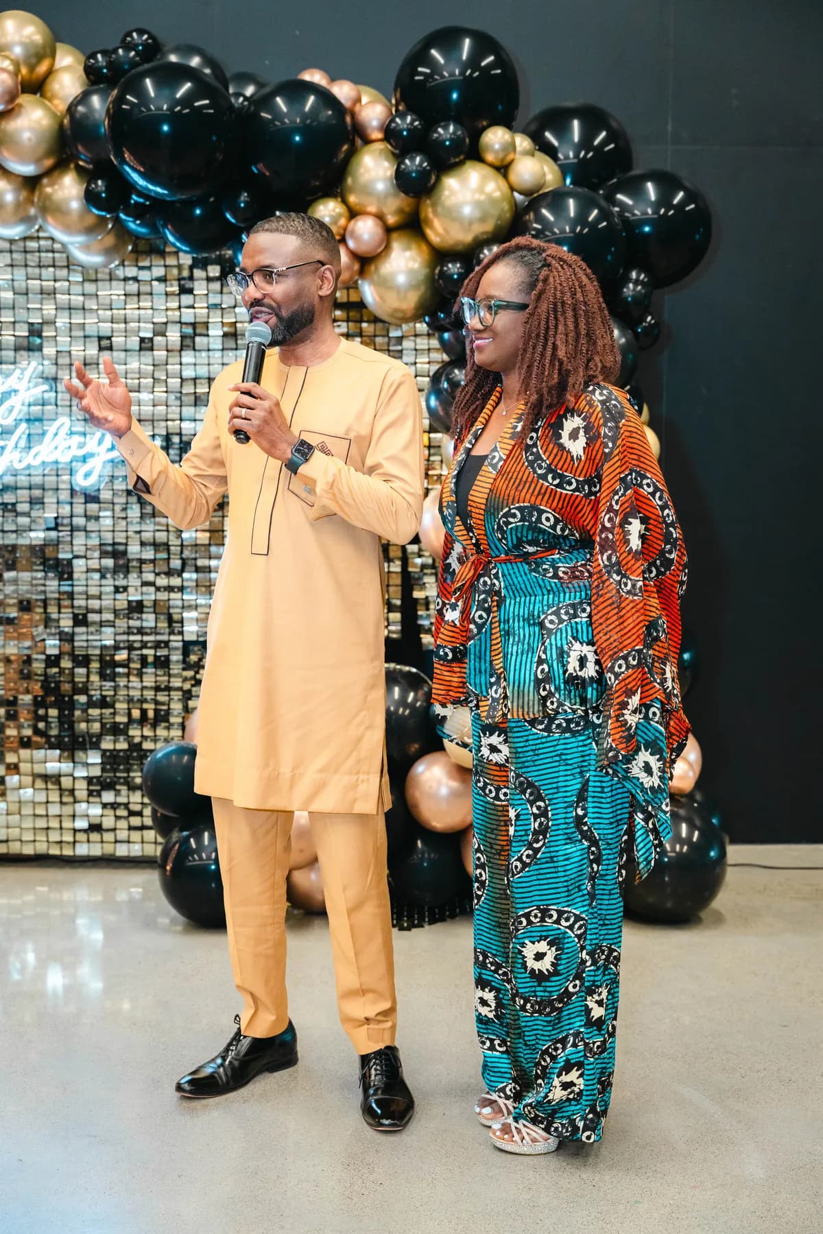 Two guests speaking to the room at BJ’s 40th birthday party.