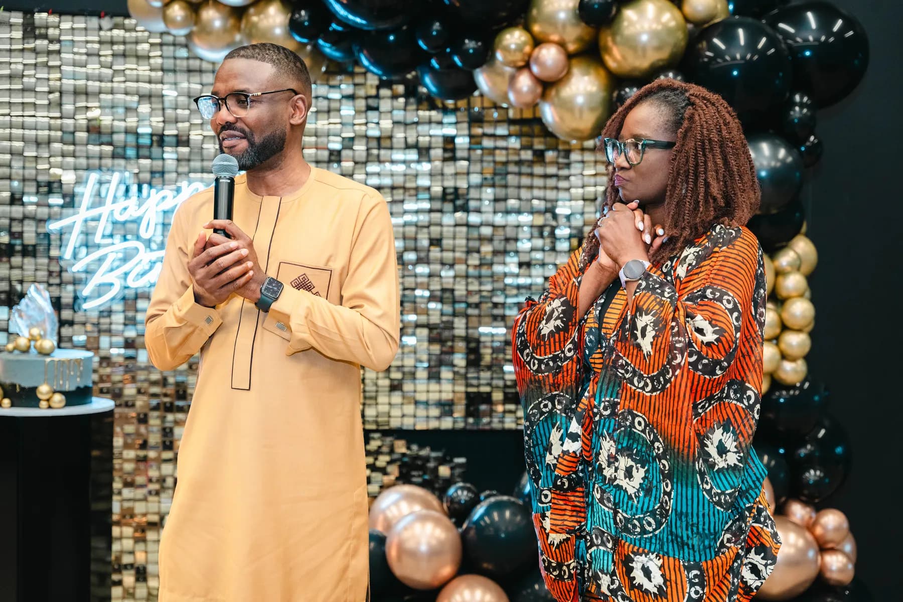 Two guests speaking to the room at BJ’s 40th birthday party.