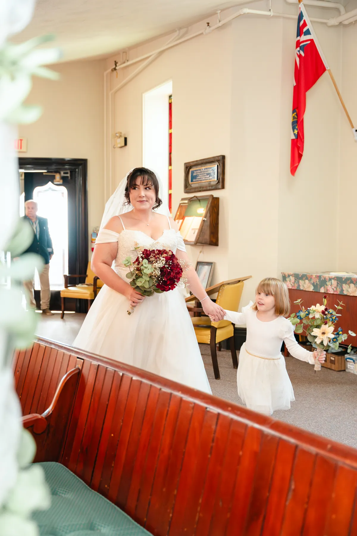 The bride entering the church with a child at Kody and Jaz’s wedding.