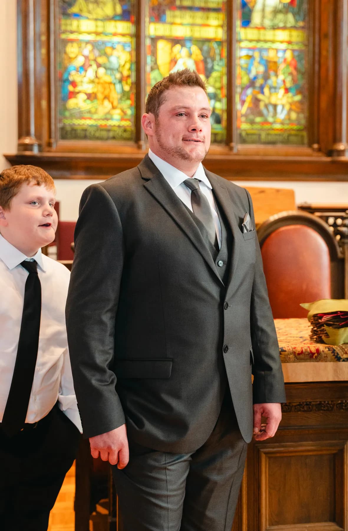 A portrait of the groom inside the church at Kody and Jaz’s wedding.
